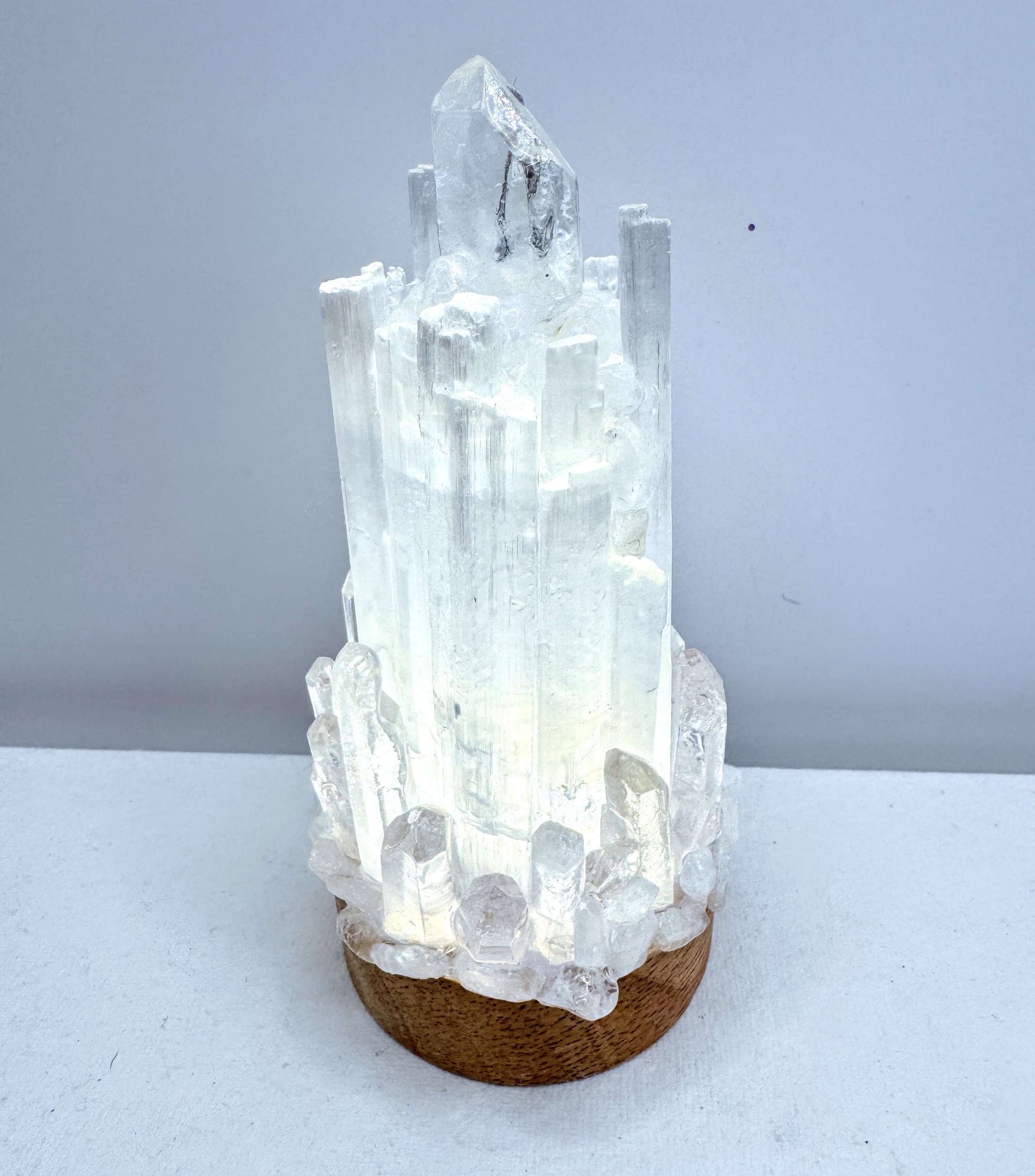 Selenite lamp showcasing crystal lamp design with Clear Quartz points illuminating a calming glow.