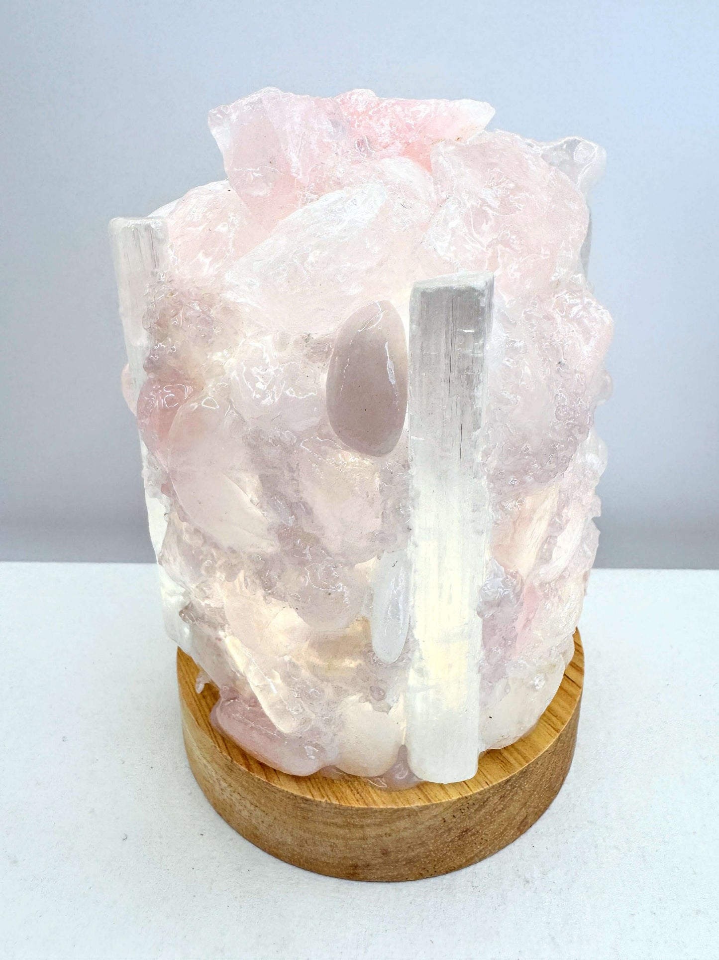 Rose Quartz & Selenite dome lamp showcasing crystal textures on a wooden base, perfect for adding a calming glow.
