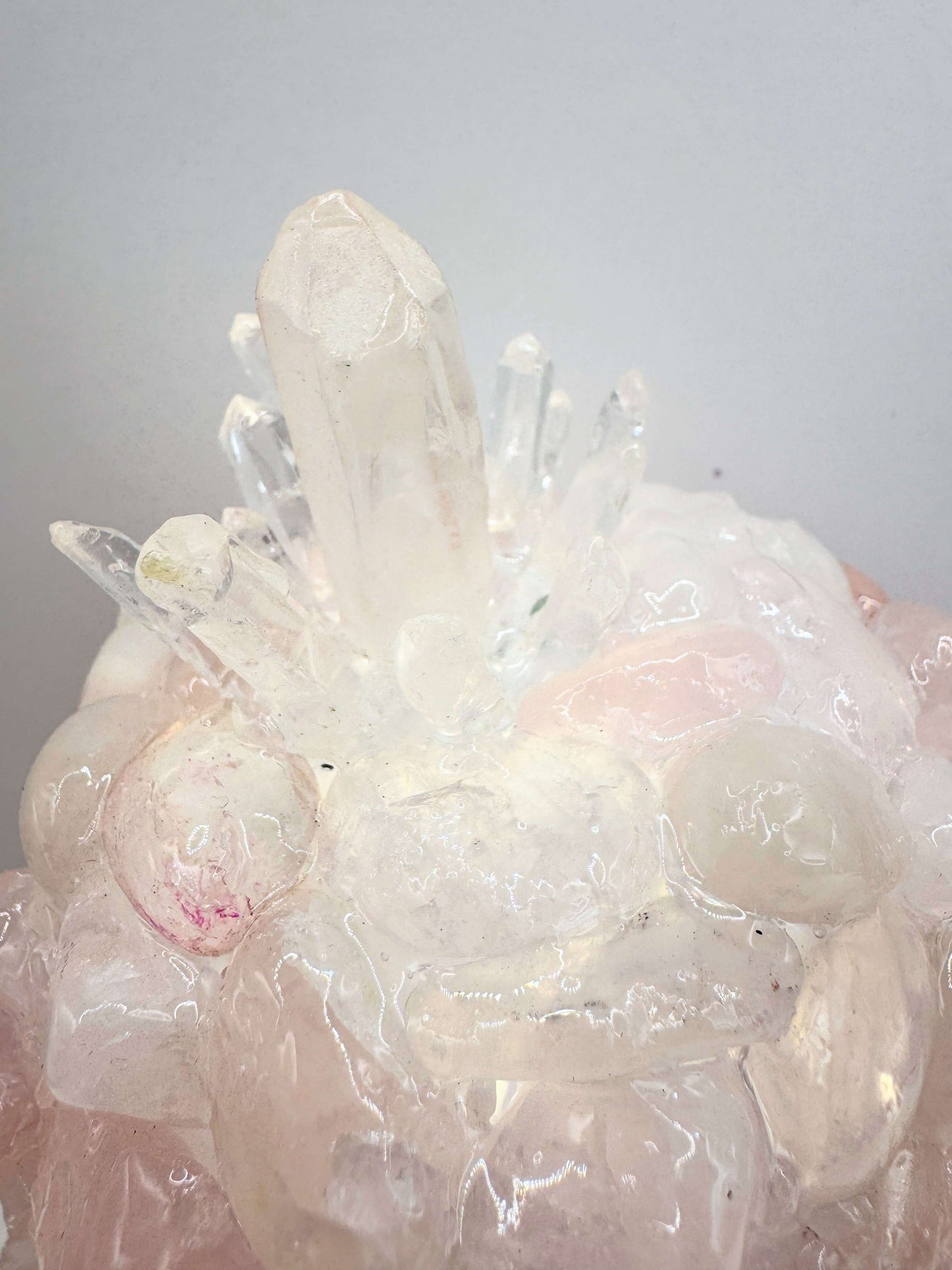 Close-up of a crystal dome lamp showcasing rose quartz and clear quartz natural crystals.