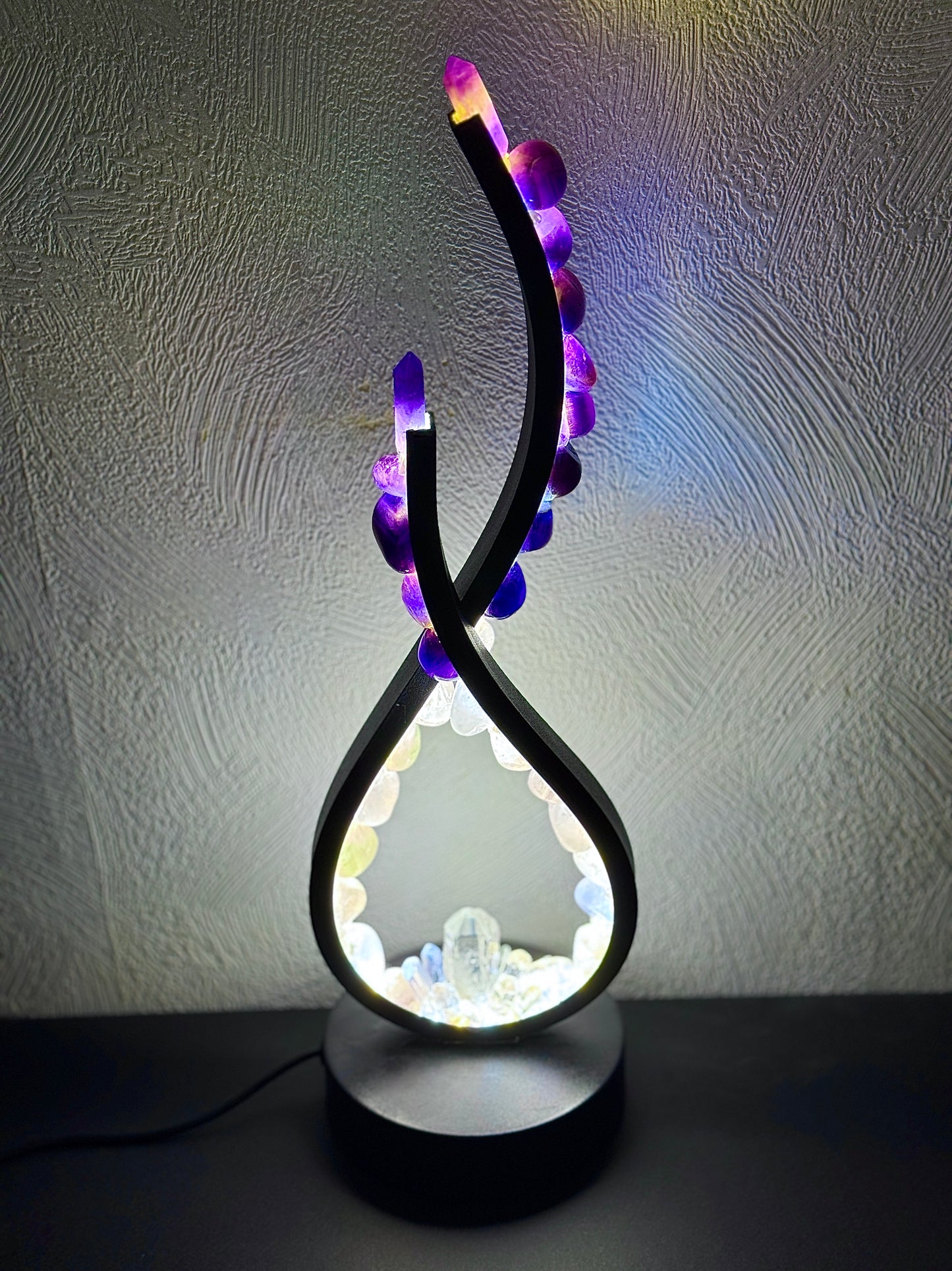 Crystal lamp with flame shape featuring rose quartz and amethyst stones, enhancing gentle heart energy with a radiant glow.
