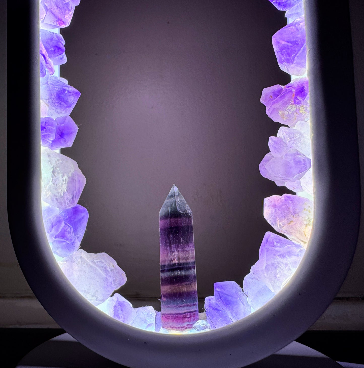 Crystal portal lamp “Fluorite Flower “ 22cm with glowing amethyst ring and fluorite center, emitting calming violet light.