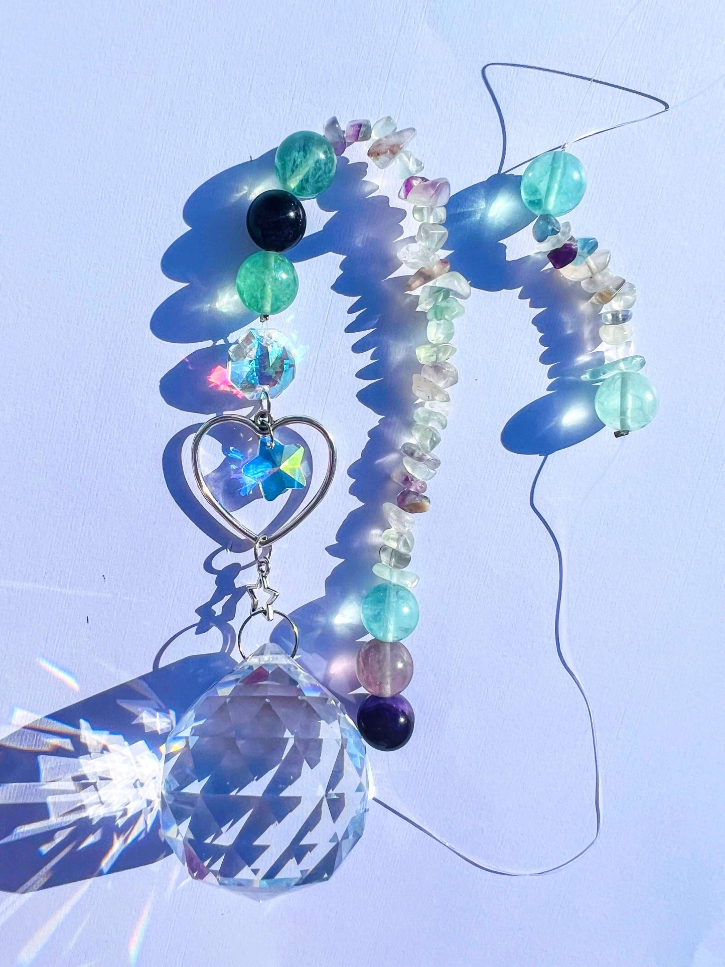 Fluorite crystal sun catcher on white background