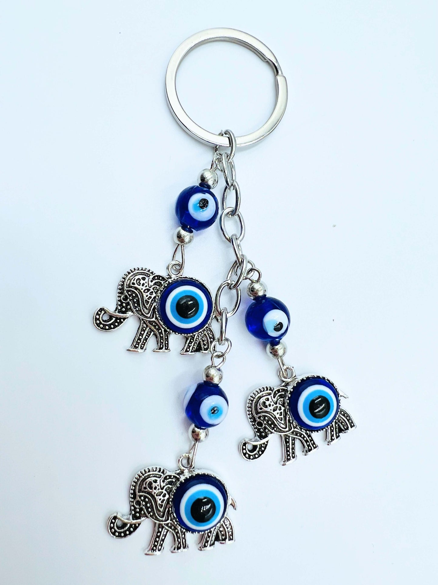 Evil Eye key ring on white surface.