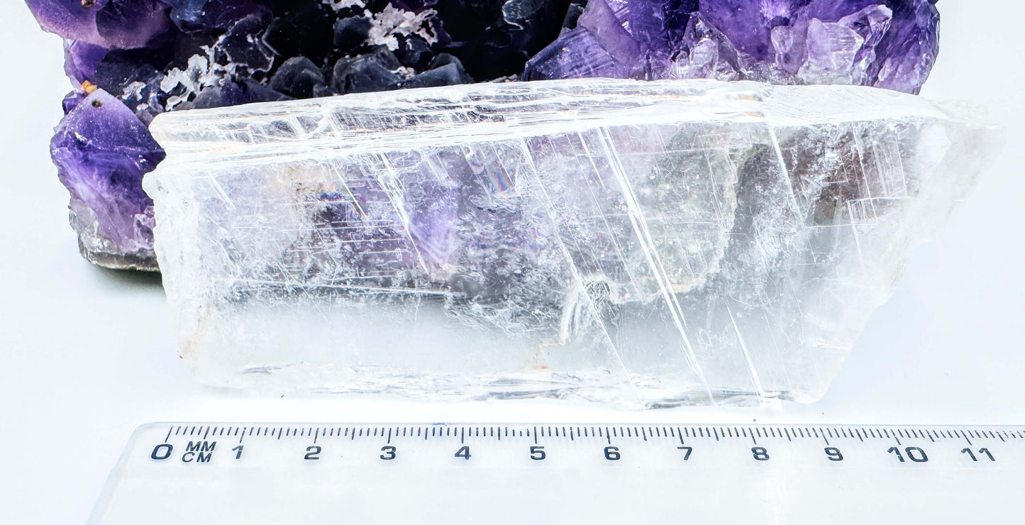 r selenite slab leaning against amethyst cluster to show the crystal’s transparency and natural clarity
