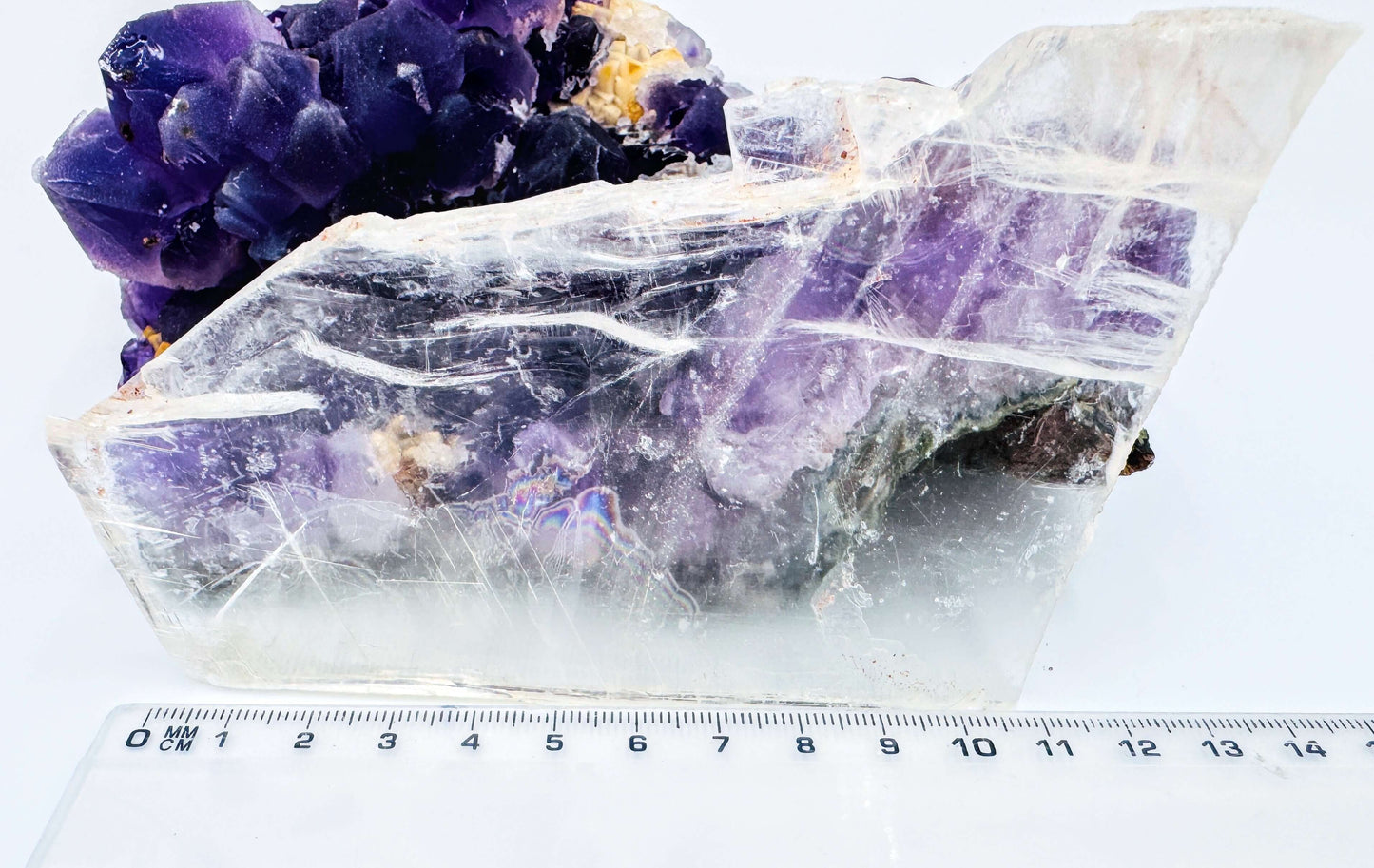 r selenite slab leaning against amethyst cluster to show the crystal’s transparency and natural clarity