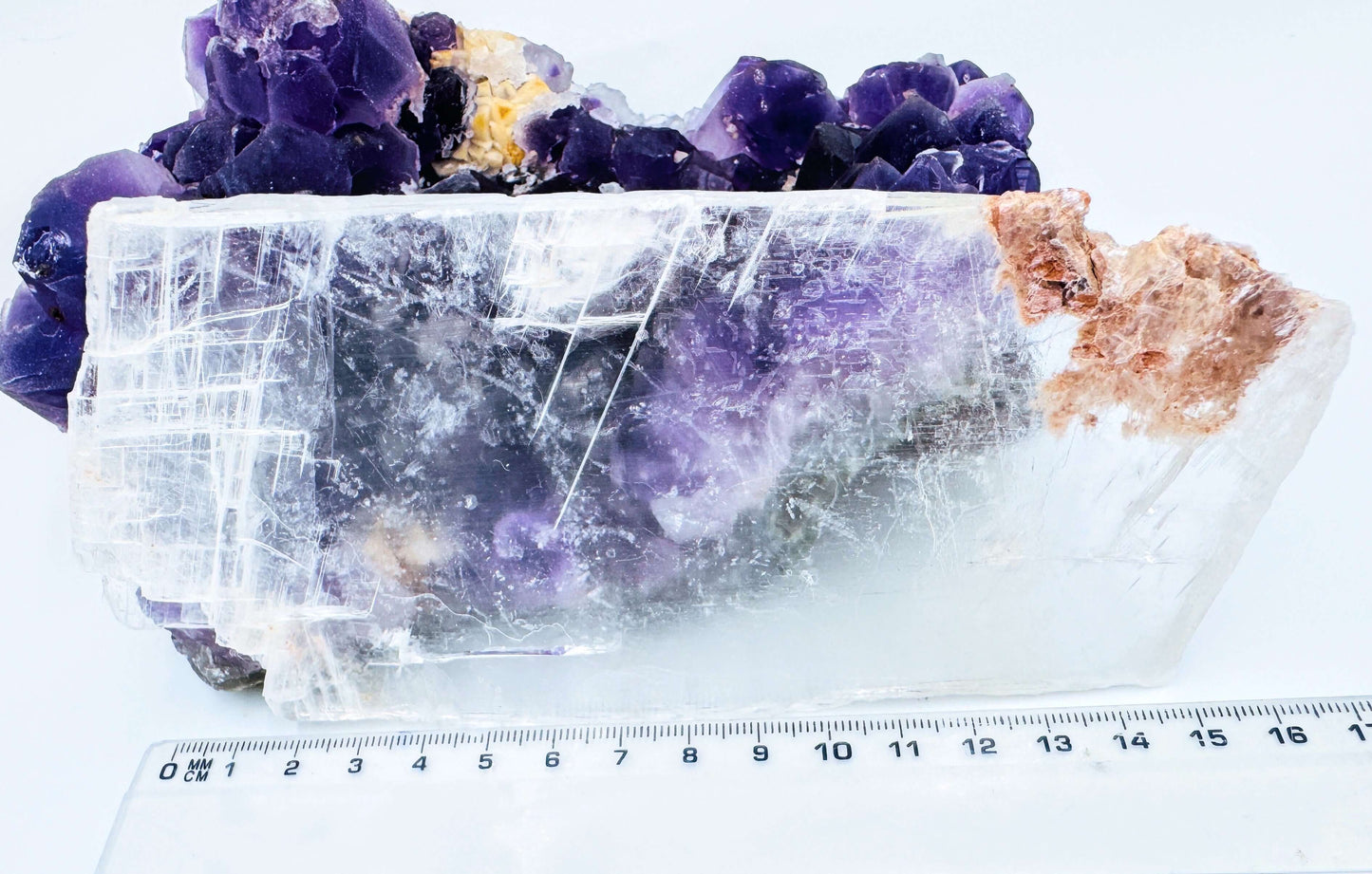 r selenite slab leaning against amethyst cluster to show the crystal’s transparency and natural clarity