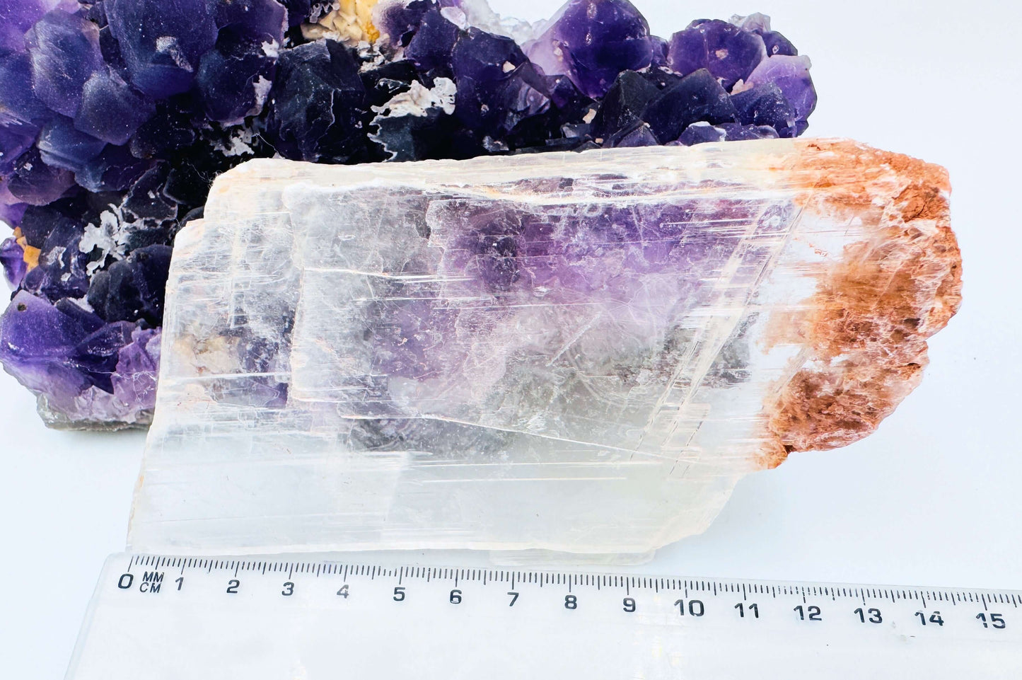 r selenite slab leaning against amethyst cluster to show the crystal’s transparency and natural clarity