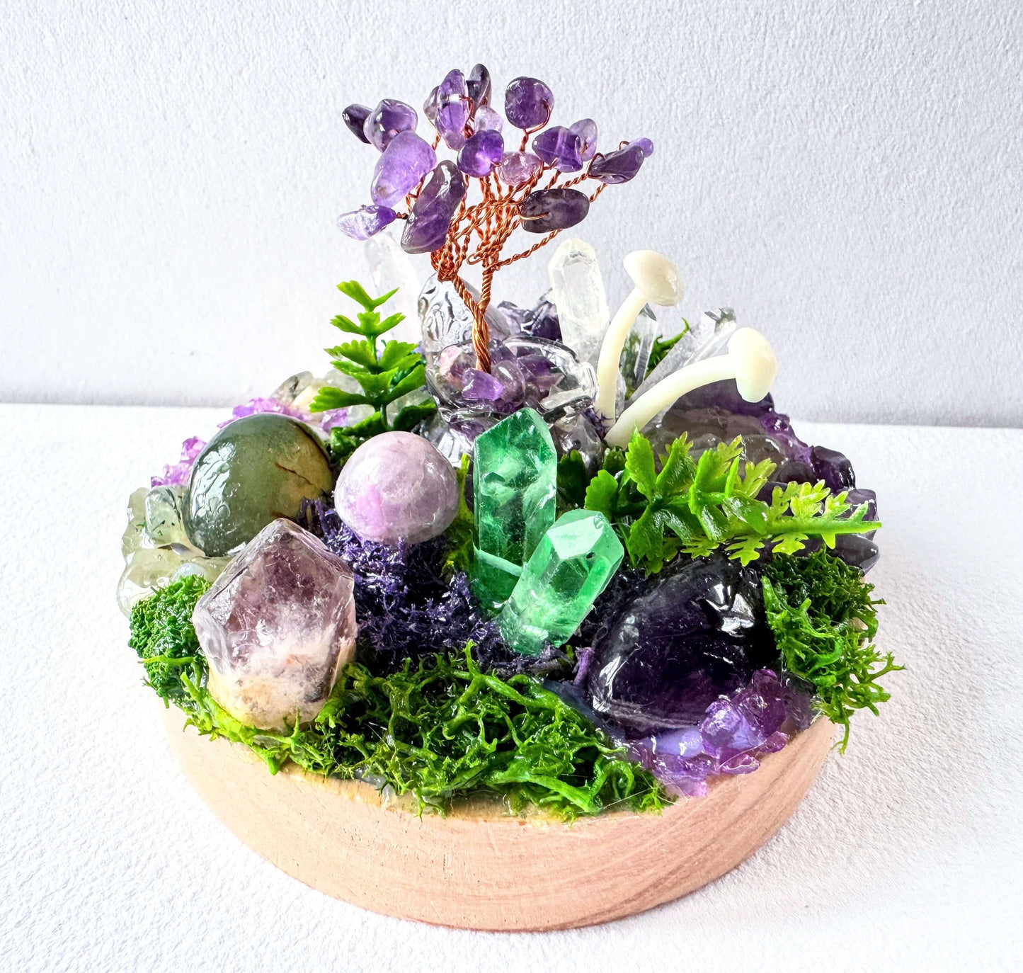 Amethyst Fairy Light Garden featuring unique crystals and plants on a wooden base, glowing as a crystal lamp.