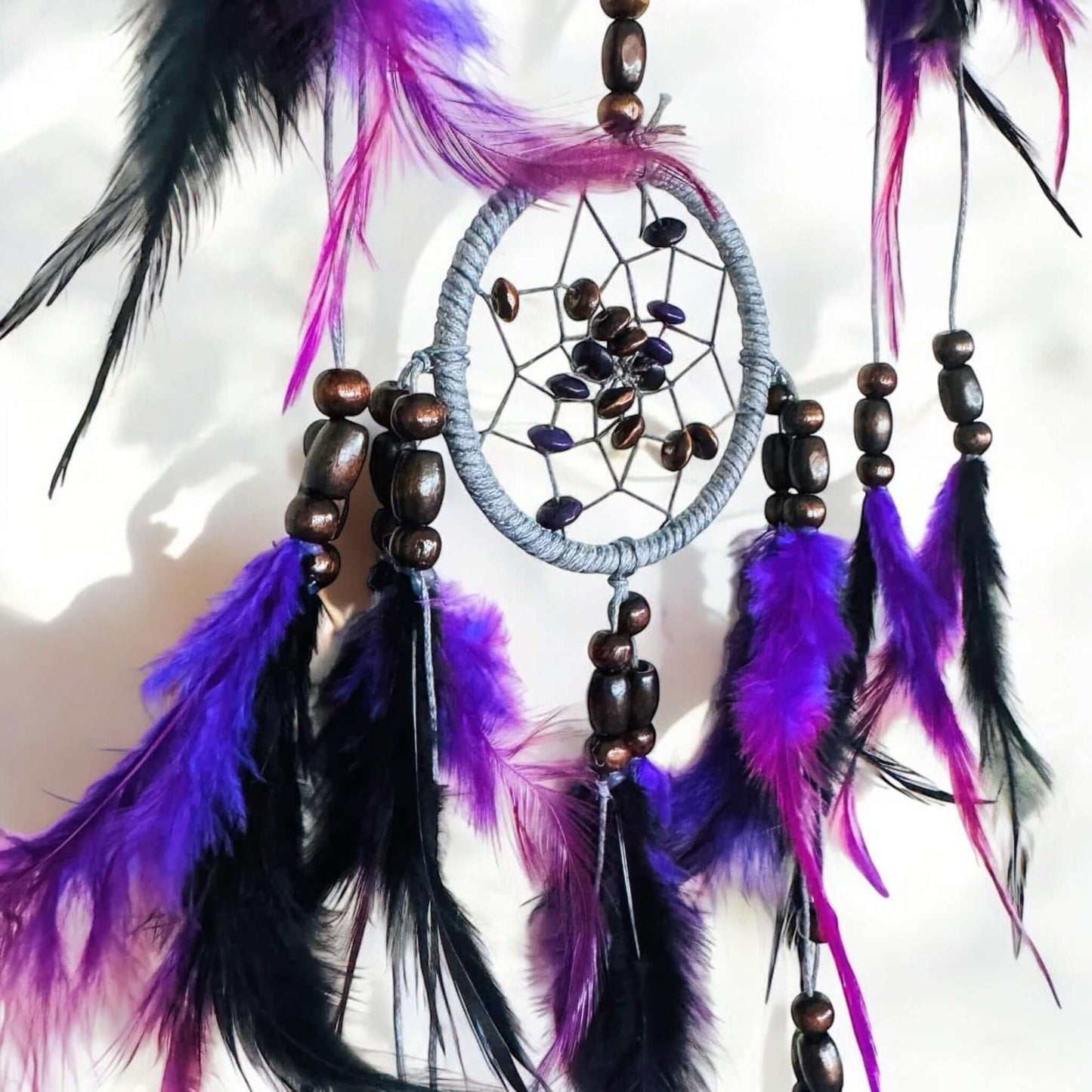 Dream Catcher with purple feathers and wood beads.