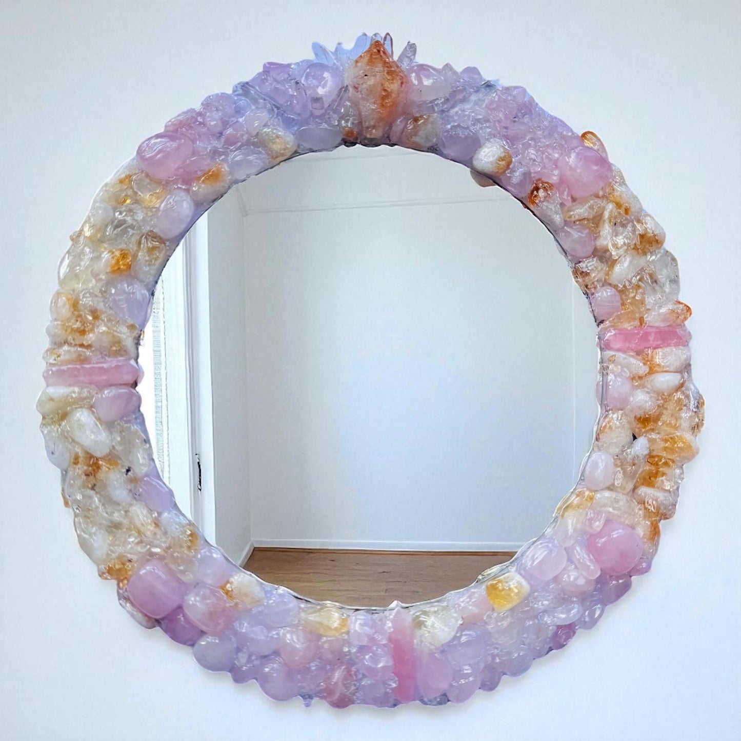 Handmade crystal mirror with gemstone border reflecting natural light