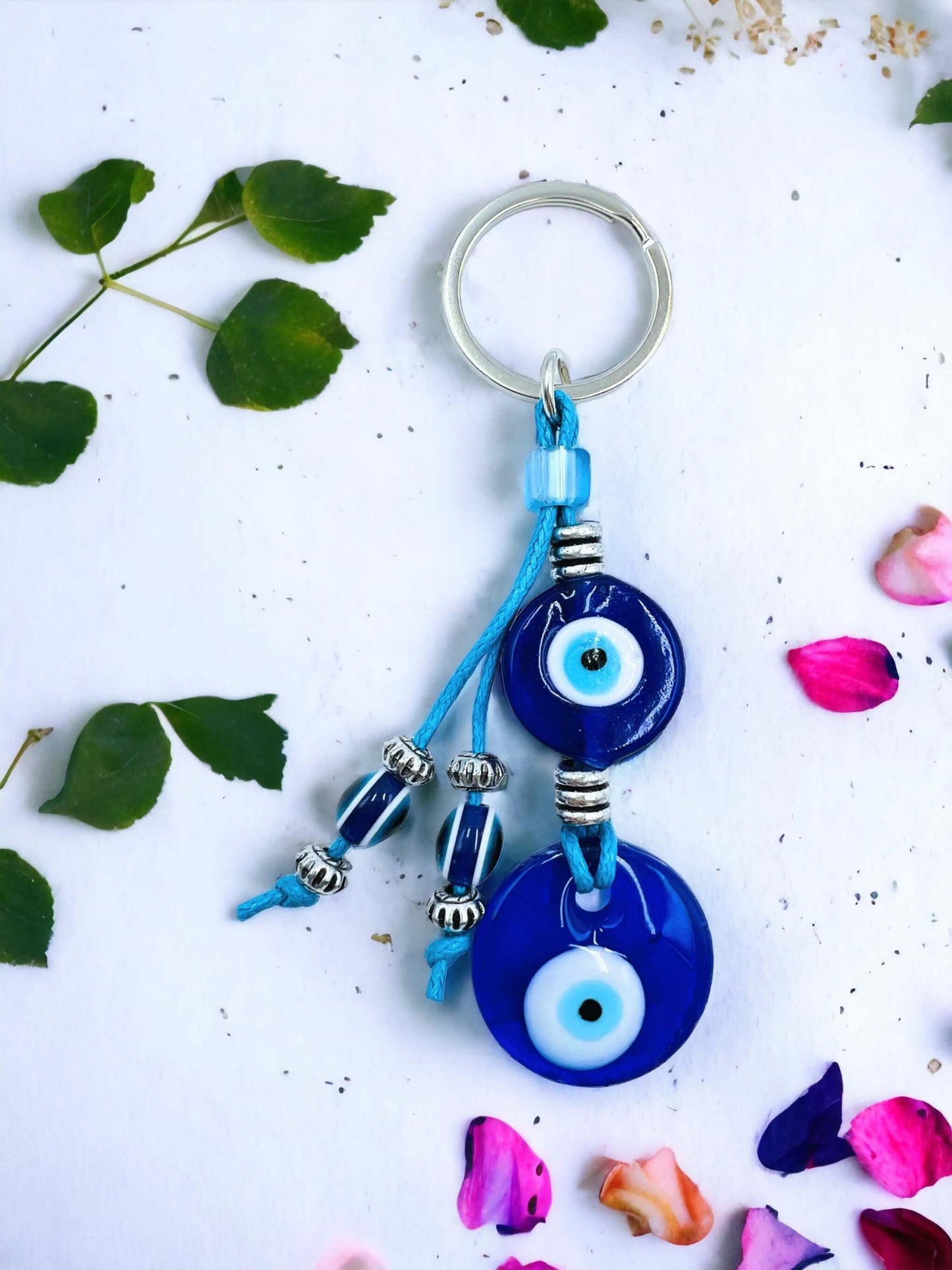 Evil Eye key ring on white surface.
