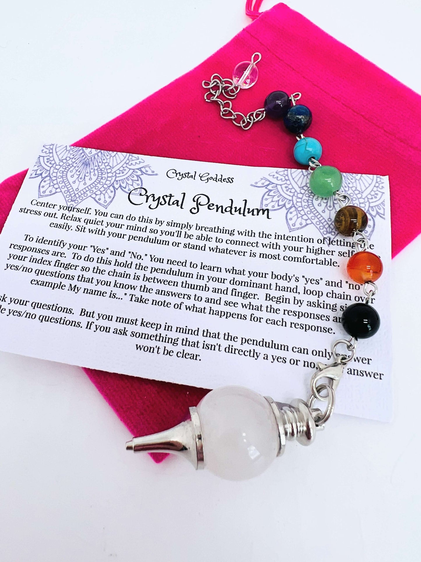Crystal pendulum with chakra bead chain on pouch with instruction card