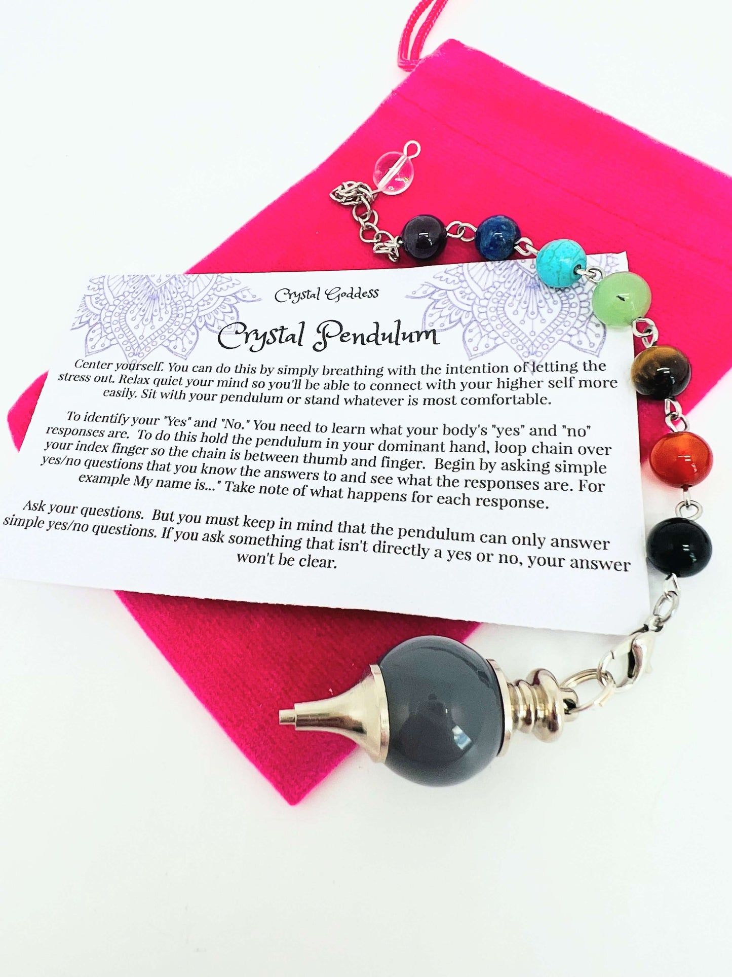 Crystal pendulum with chakra bead chain on pouch with instruction card