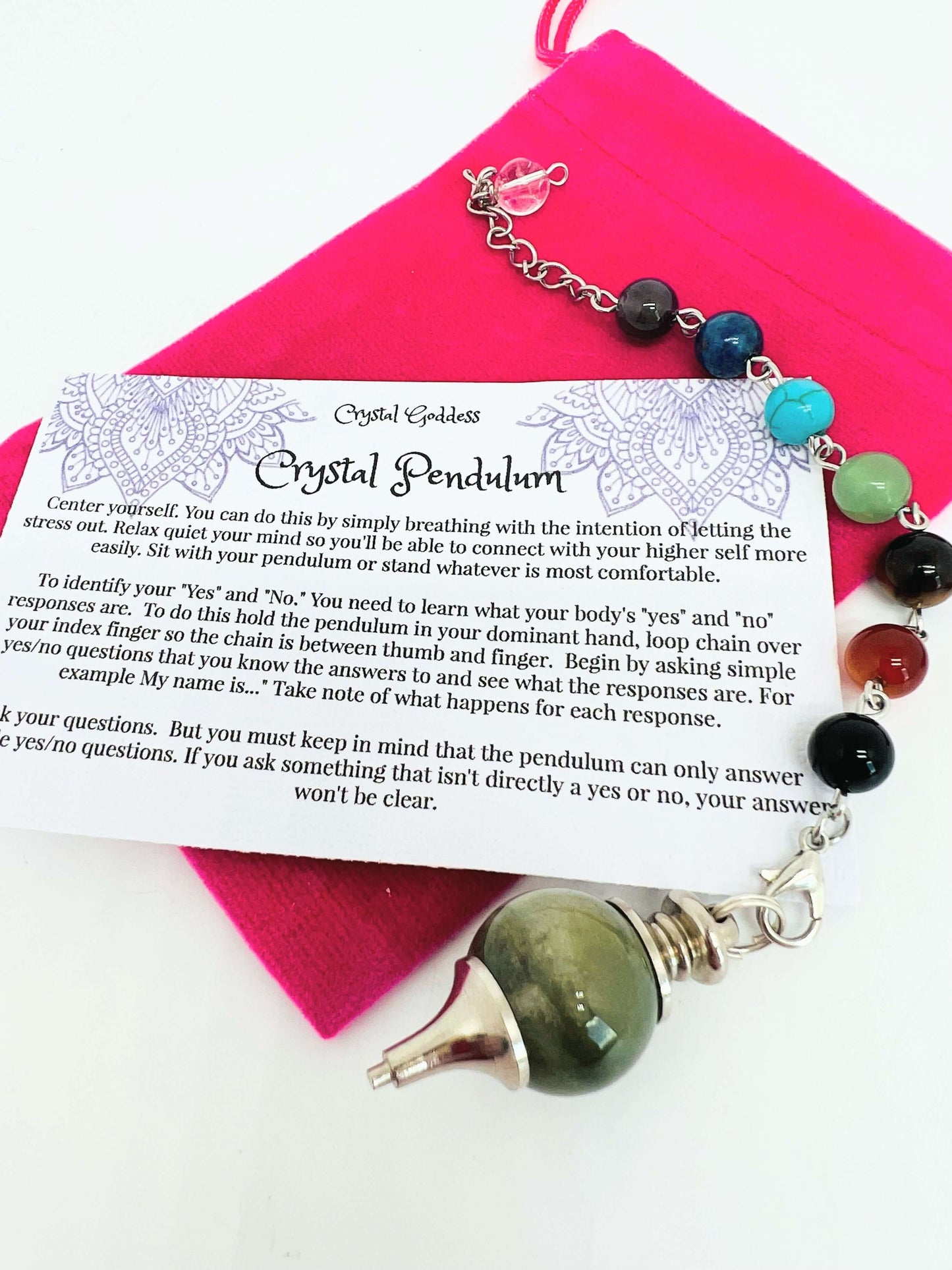 Crystal pendulum with chakra bead chain on pouch with instruction card