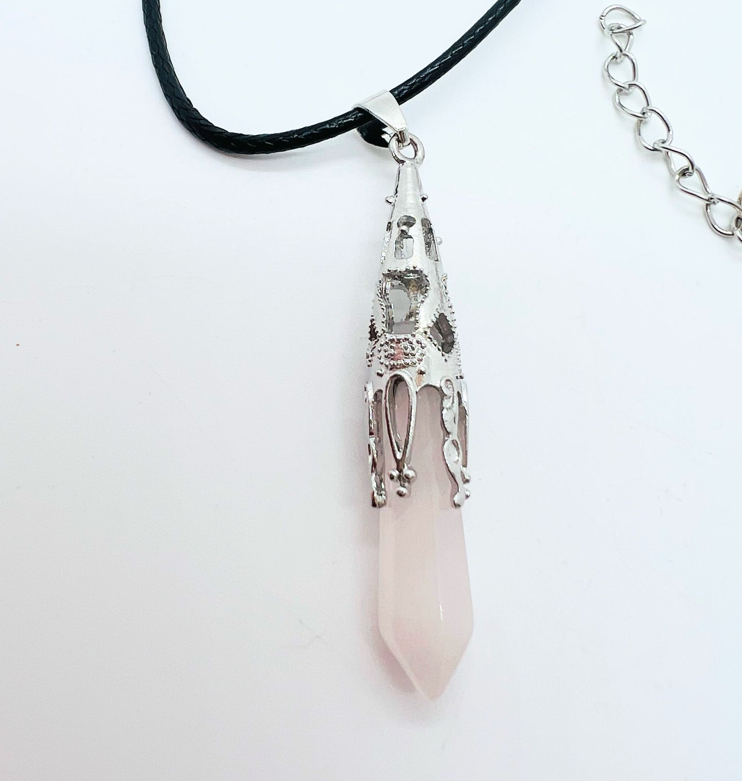Rose quartz pendant on white background