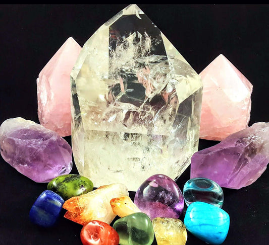 Assorted crystals display for learning how to choose the right crystals; clear quartz, rose quartz, amethyst, and colorful stones