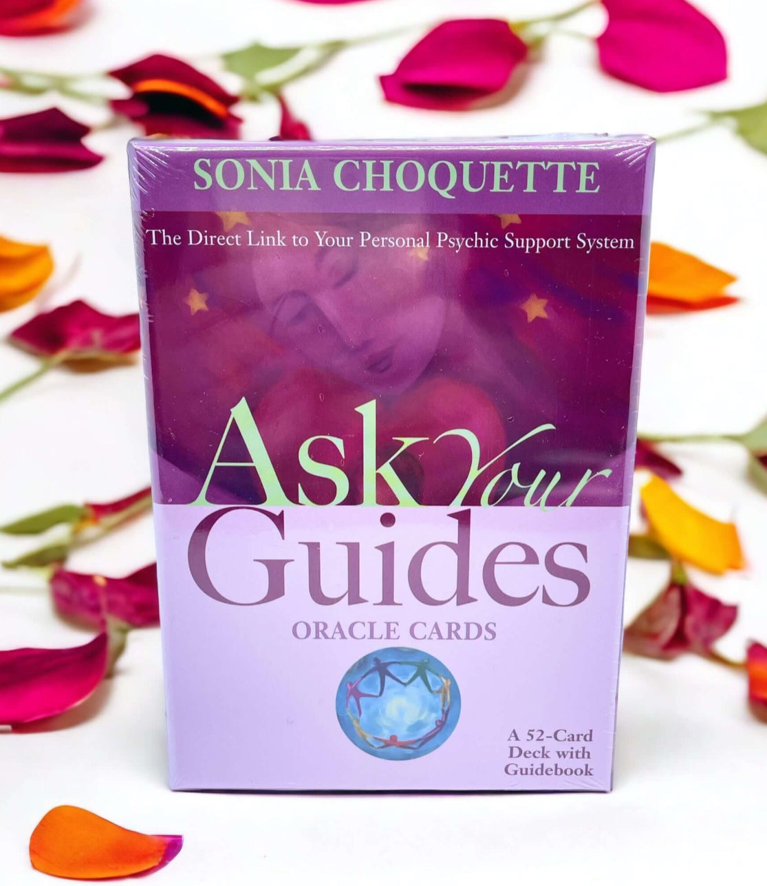 "Ask Your Guides" oracle cards deck surrounded by rose petals, featuring 52 cards and a guidebook.