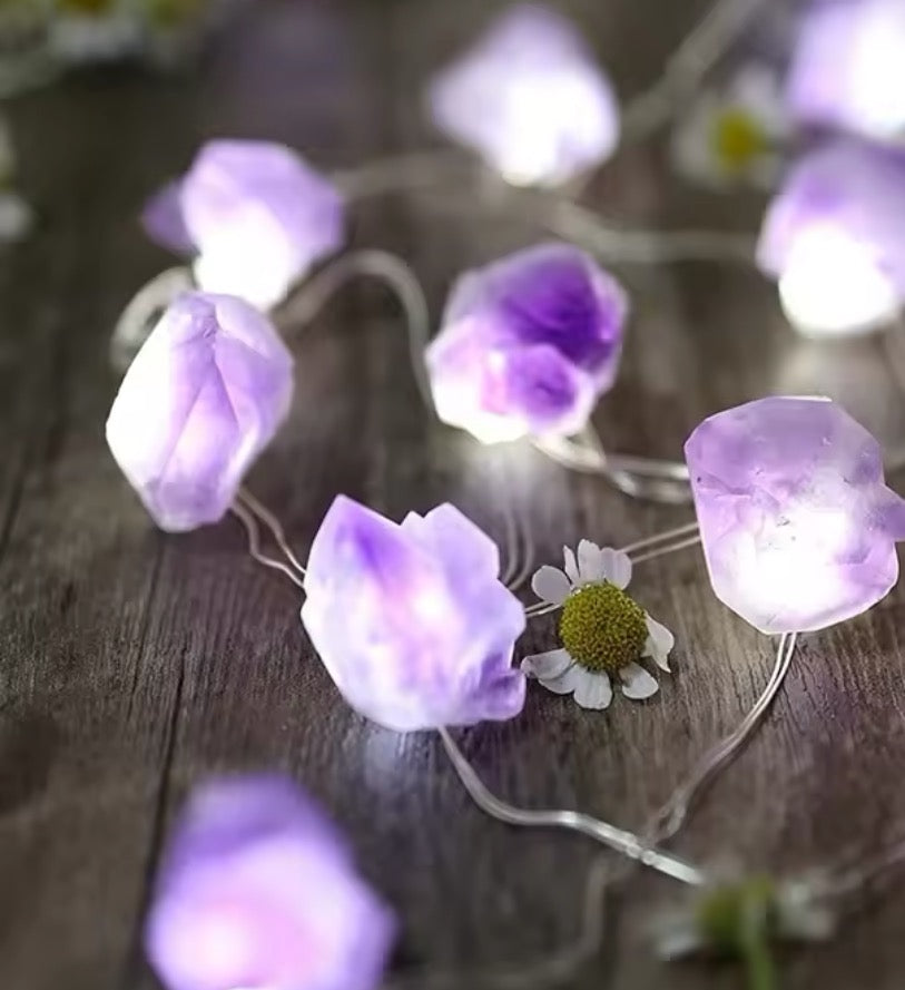 crystal fairy lights glowing with purple hues on a wooden surface, creating a magical ambiance