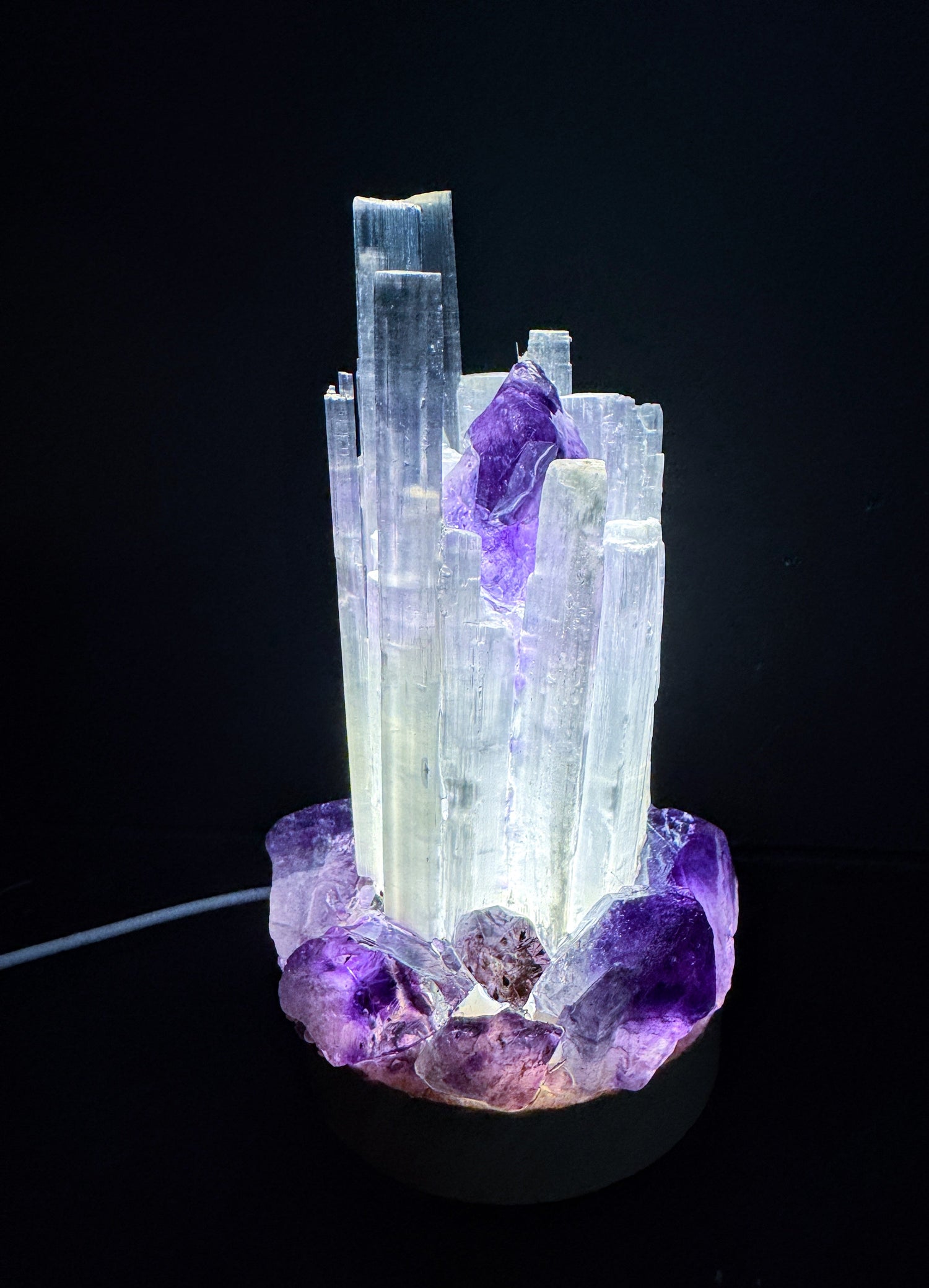 Crystal cluster lamps with rainbow LED light and wooden base, offering unique energetic designs for calm and clarity.