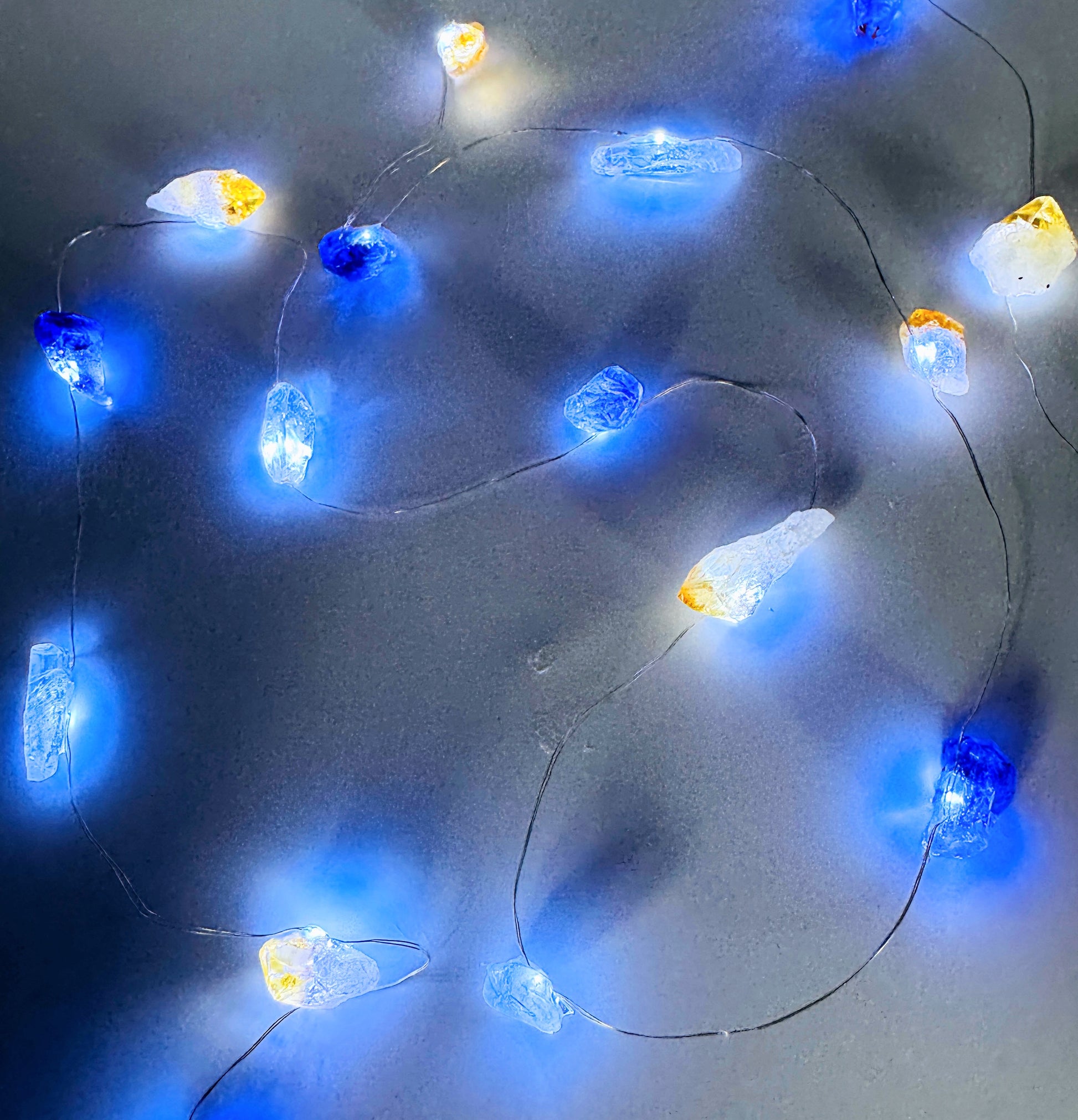 Crystal fairy lights featuring clear quartz, amethyst, and citrine stones with a cool-toned glow, 2m length with 8 light modes.