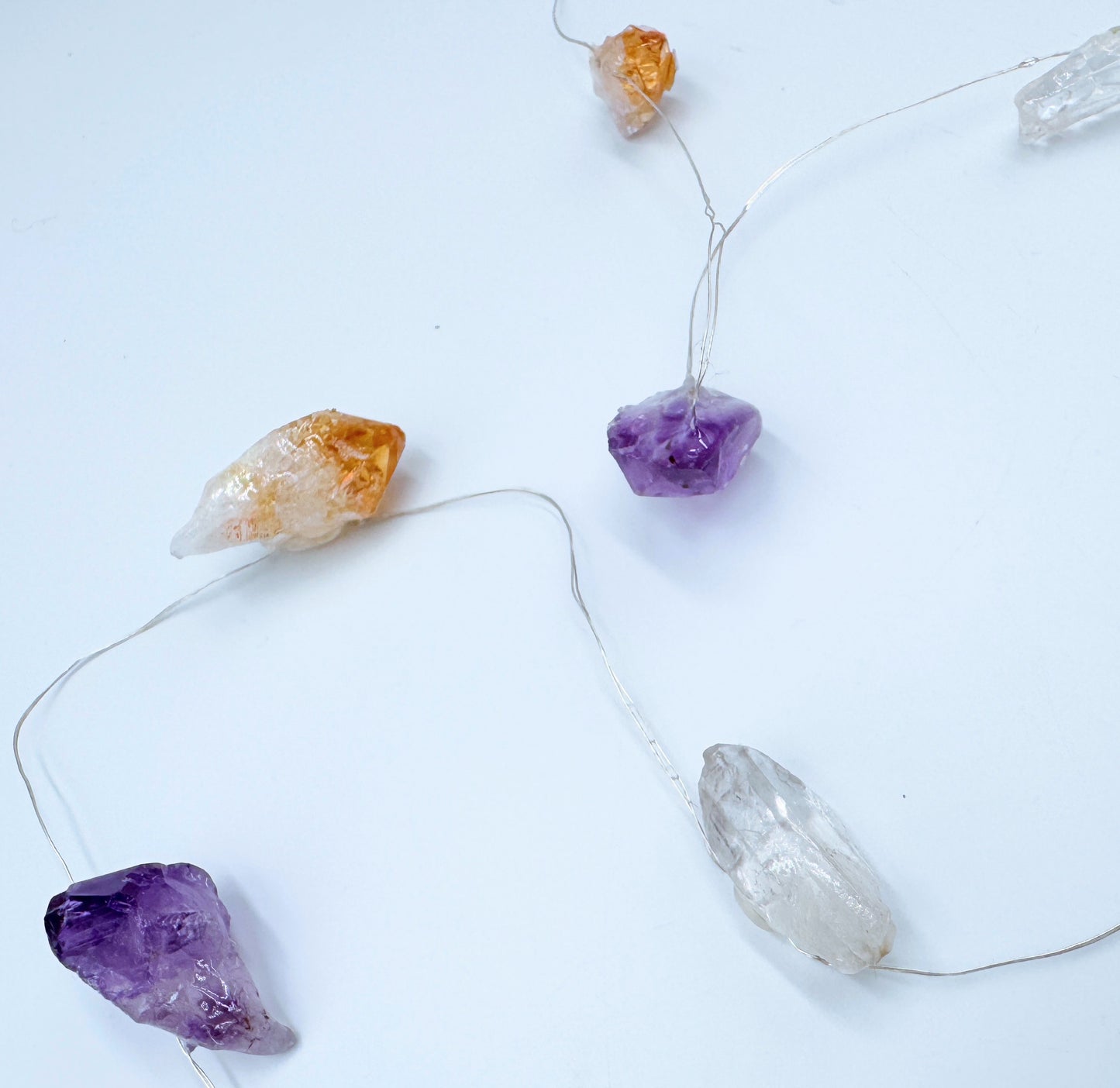 Crystal fairy lights featuring clear quartz, amethyst, and citrine stones with a cool-toned glow, 2m length with 8 light modes.
