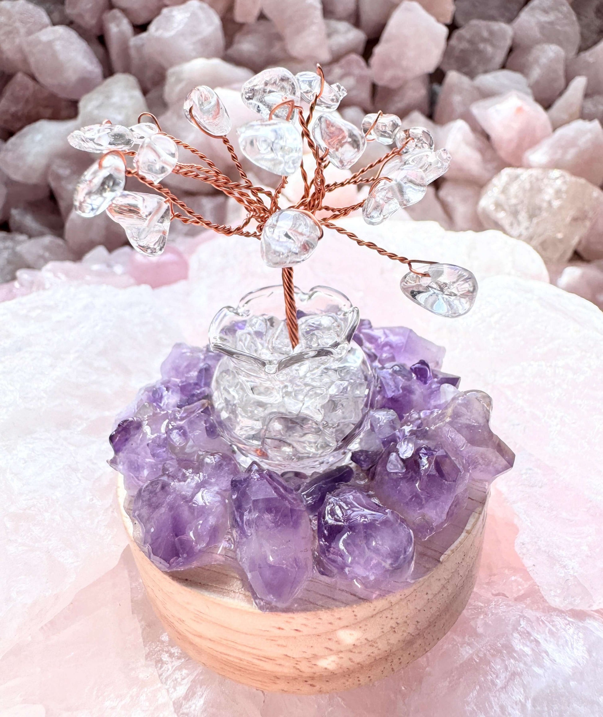 Crystal lamp featuring clear quartz tree over amethyst cluster on a wooden base, lit by a rainbow LED light.