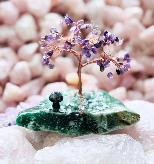Handcrafted amethyst crystal tree on aventurine base with moss agate mushroom for spiritual calm and prosperity.