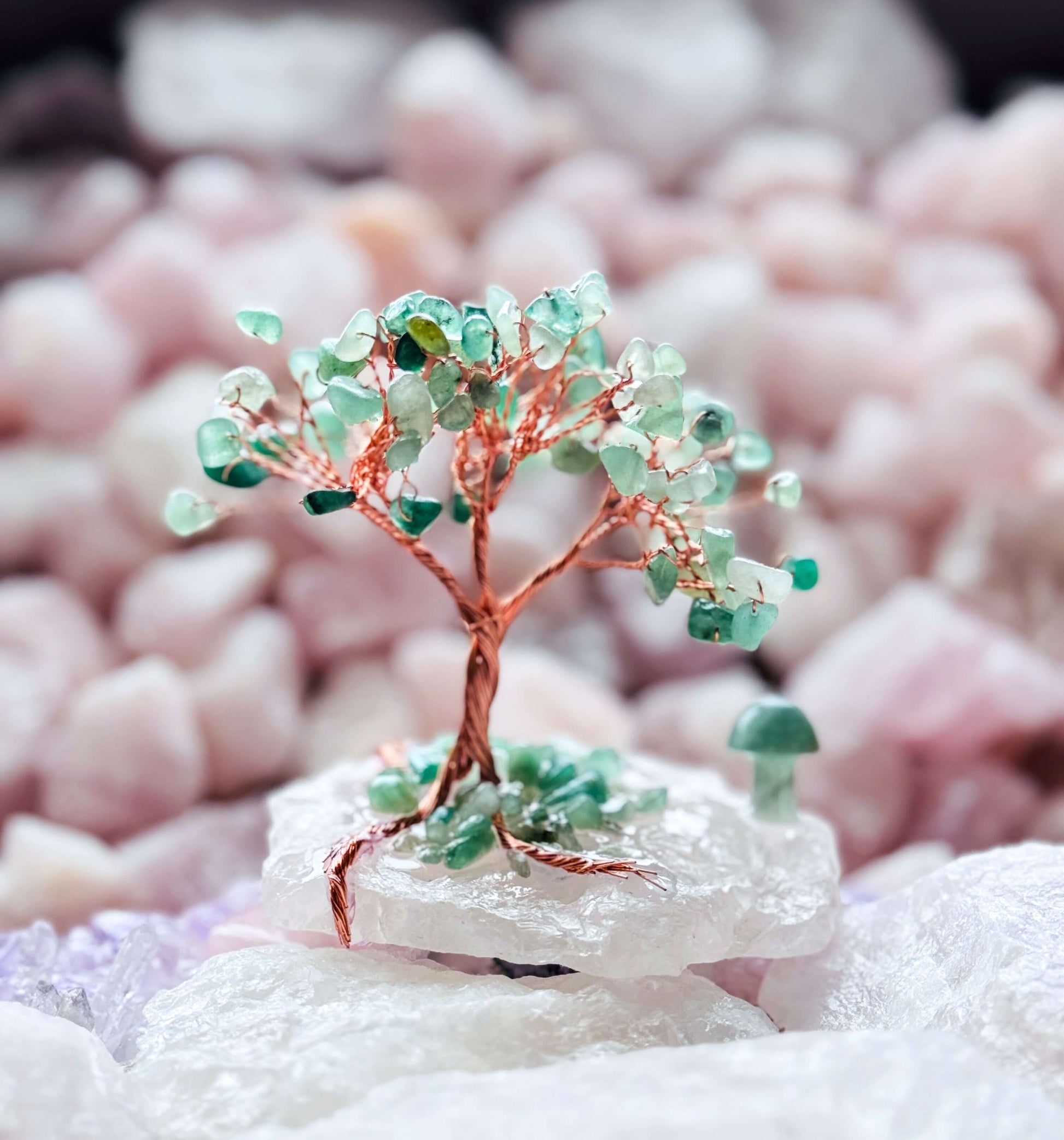 Handcrafted crystal trees with Green Aventurine branches on a Rose Quartz base, featuring a small carved mushroom detail.