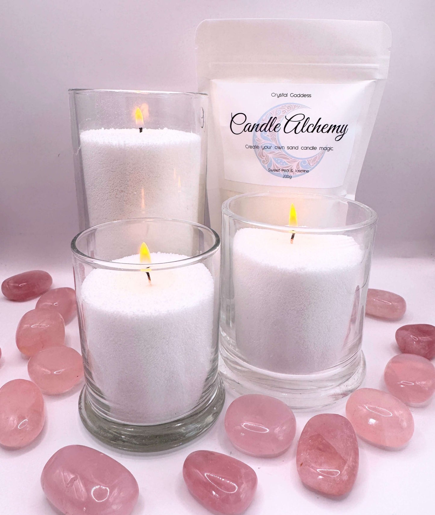 Candle Alchemy sand candles displayed with crystals, showcasing unique sand candle magic.