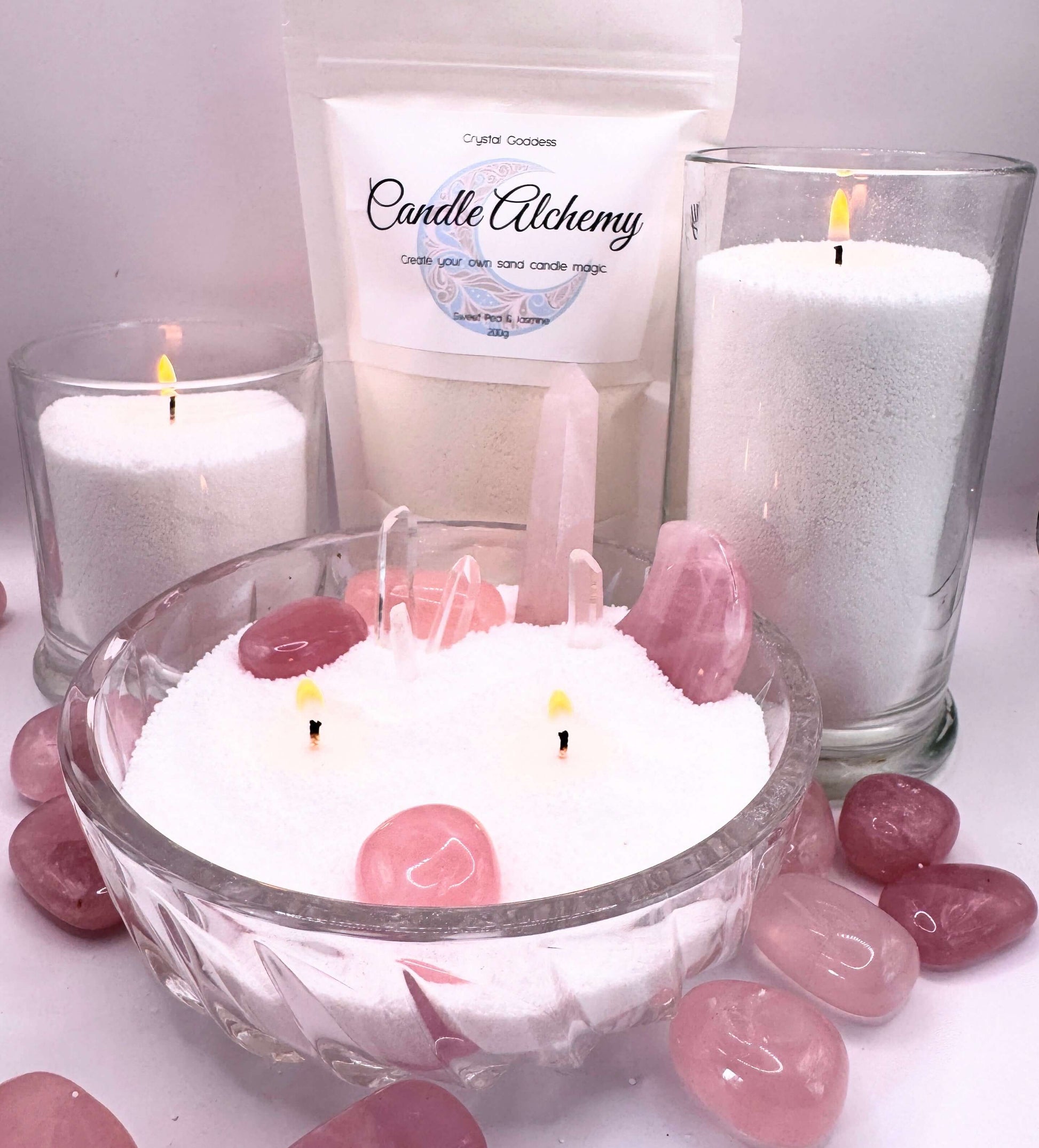 Candle Alchemy sand candles with vibrant crystals and candles in a bowl of sand.