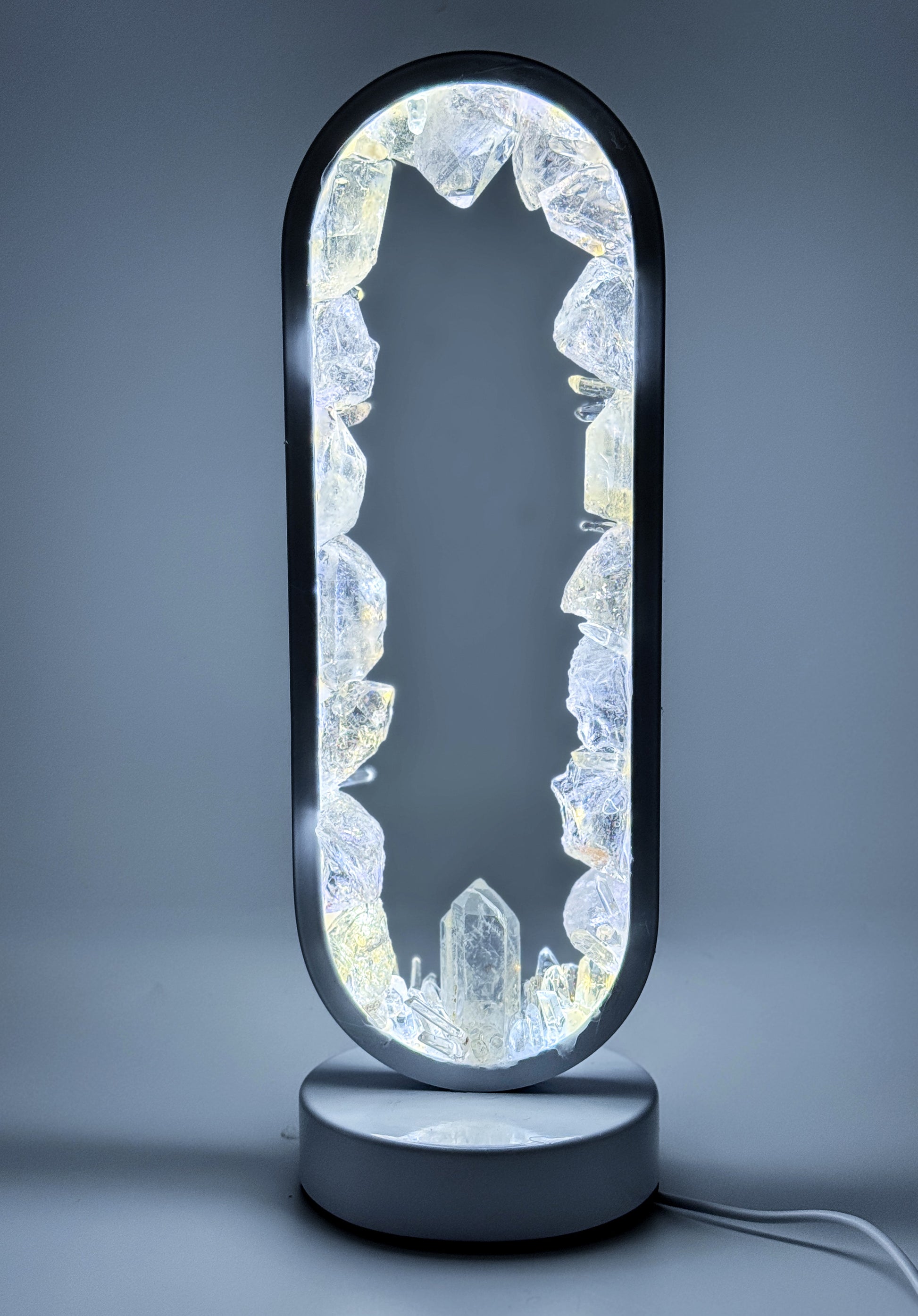 Seer - Crystal Portal Lamp made of clear quartz with LED illumination and ethereal reflections
