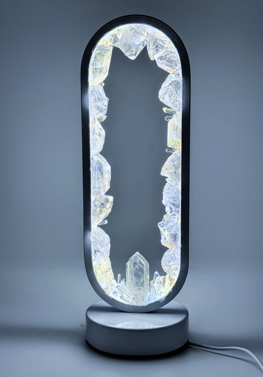 Seer - Crystal Portal Lamp made of clear quartz with LED illumination and ethereal reflections