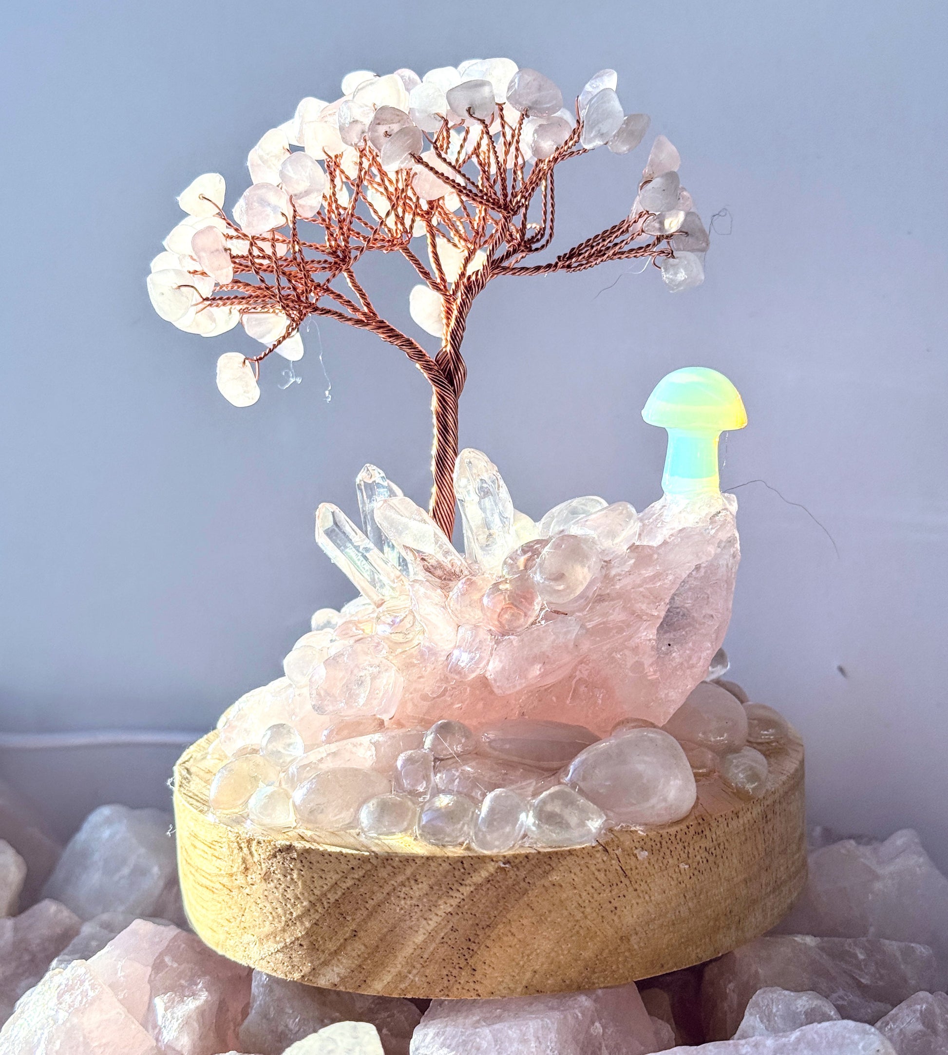 Crystal cluster lamp with Rose Quartz, Clear Quartz, and Opalite featuring a gemstone tree on a wooden base.