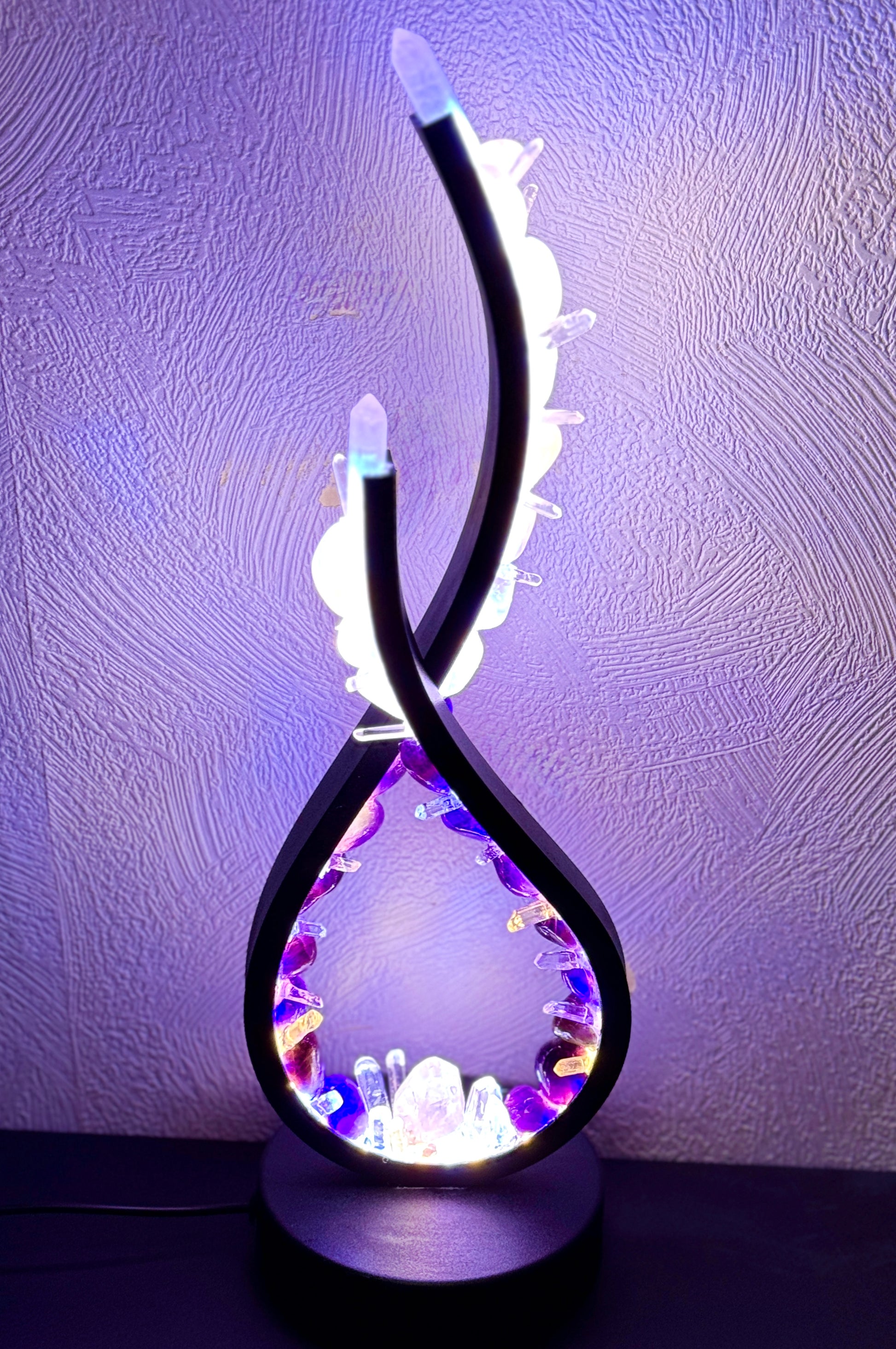 Crystal Lamp Harmony Flame with amethyst and rose quartz crystals, symbolizing love and intuition, emits a luminous spiritual energy.