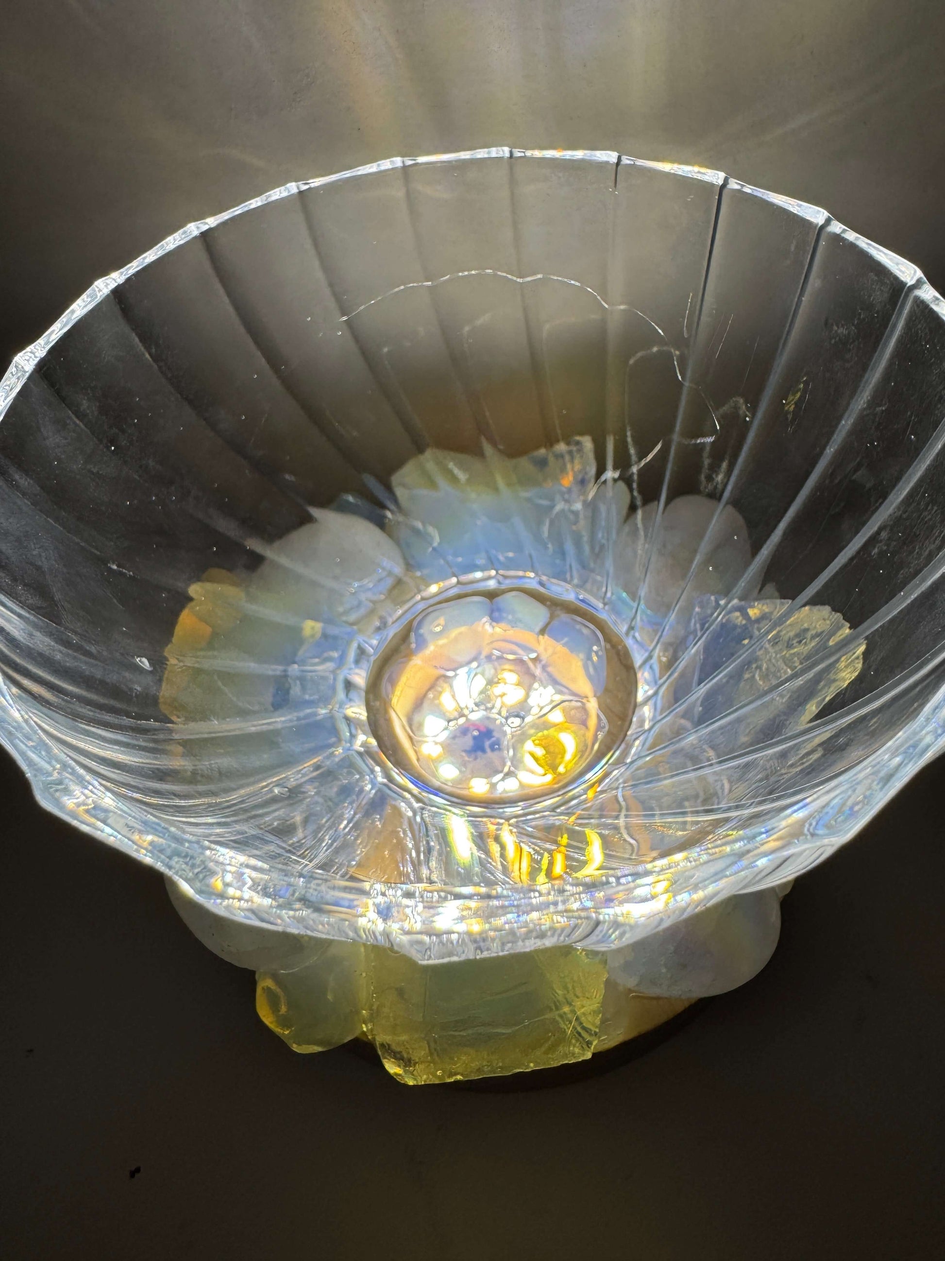 Opal Glow crystal light bowl with opalite and angel aura quartz on LED base, illuminating with iridescent colors.