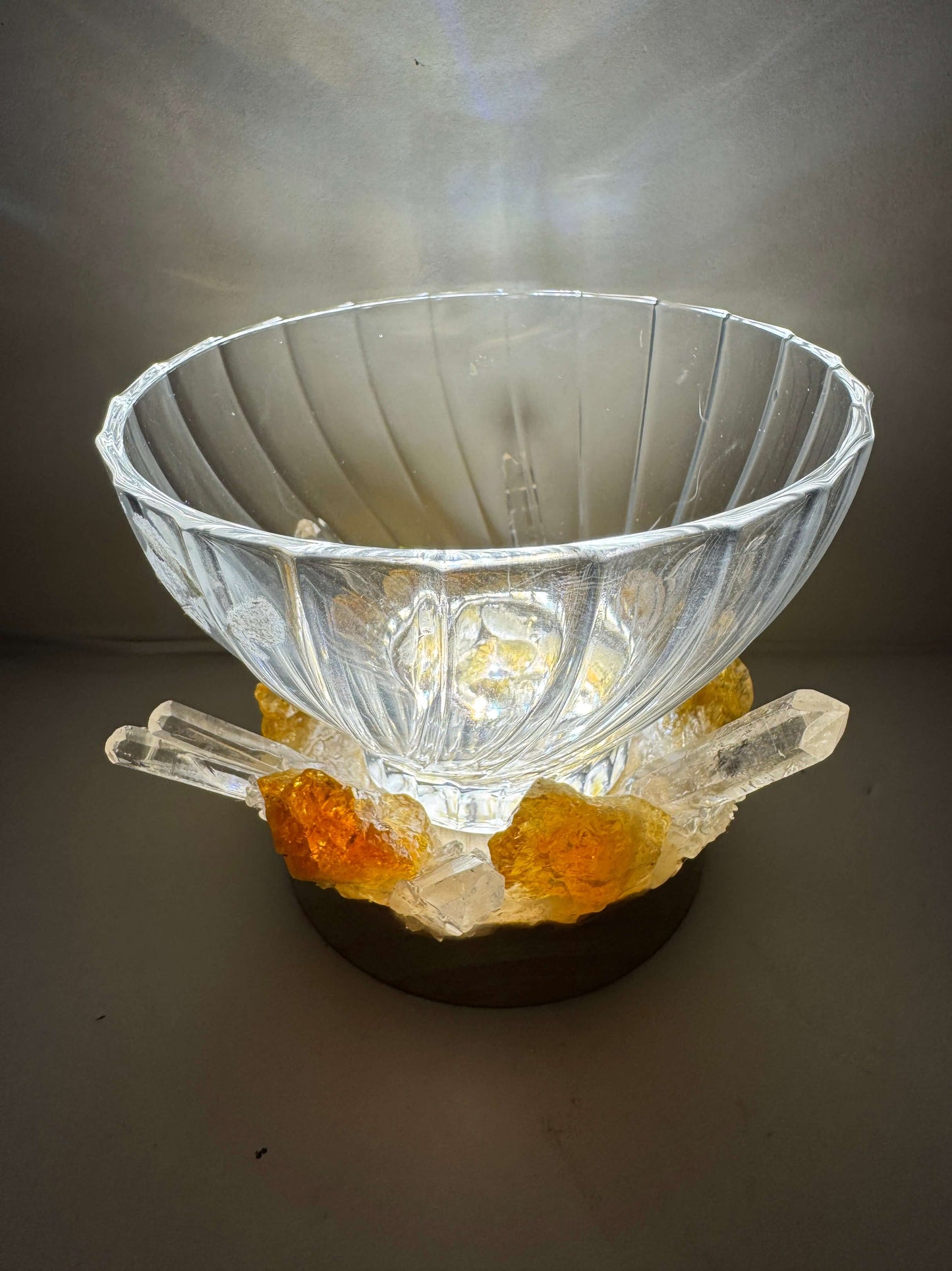 Golden Glow crystal light bowl with citrine and clear quartz on wooden LED base, emitting a warm ambient glow.