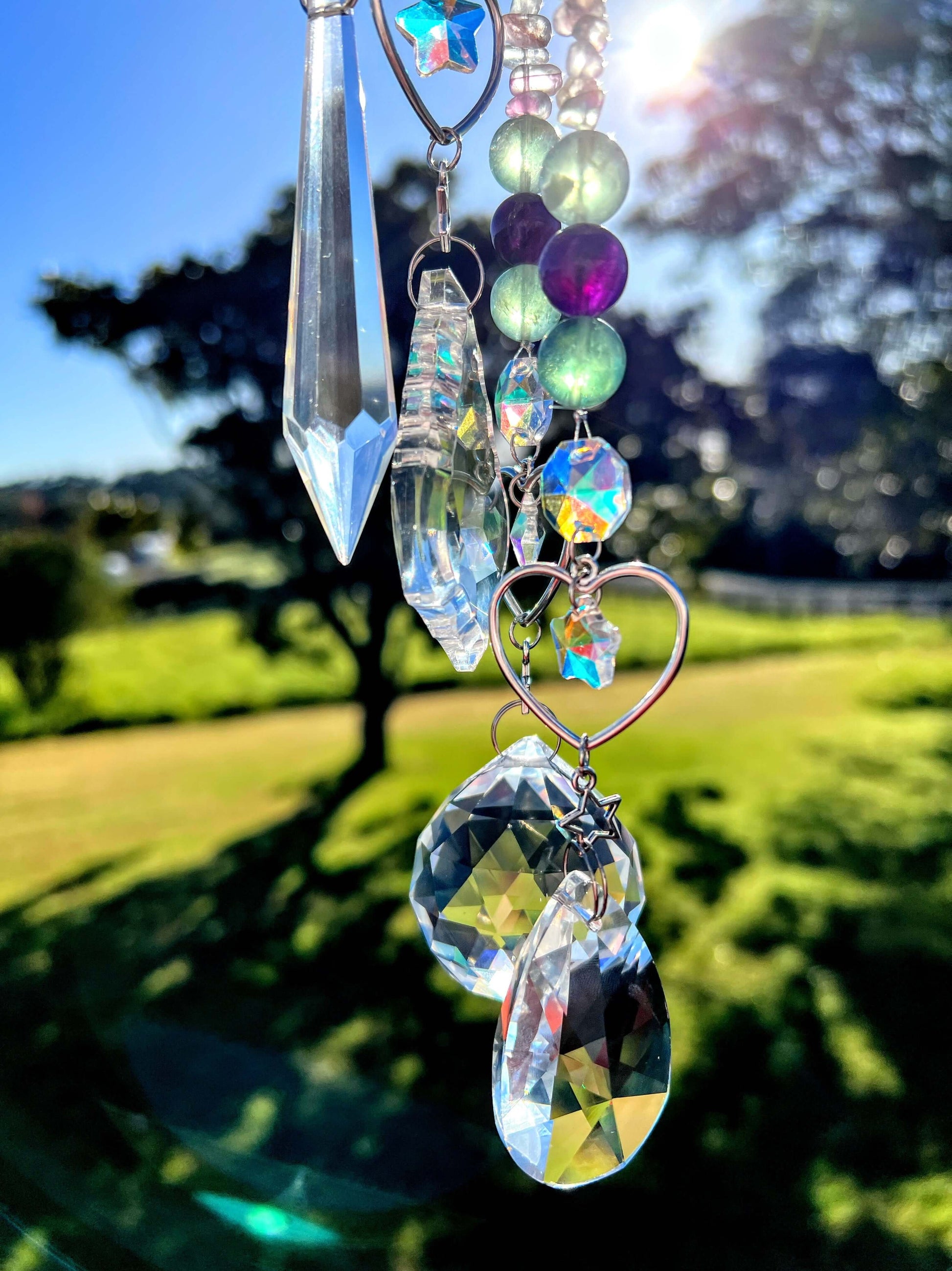 Fluorite crystal suncatchers with farm land background