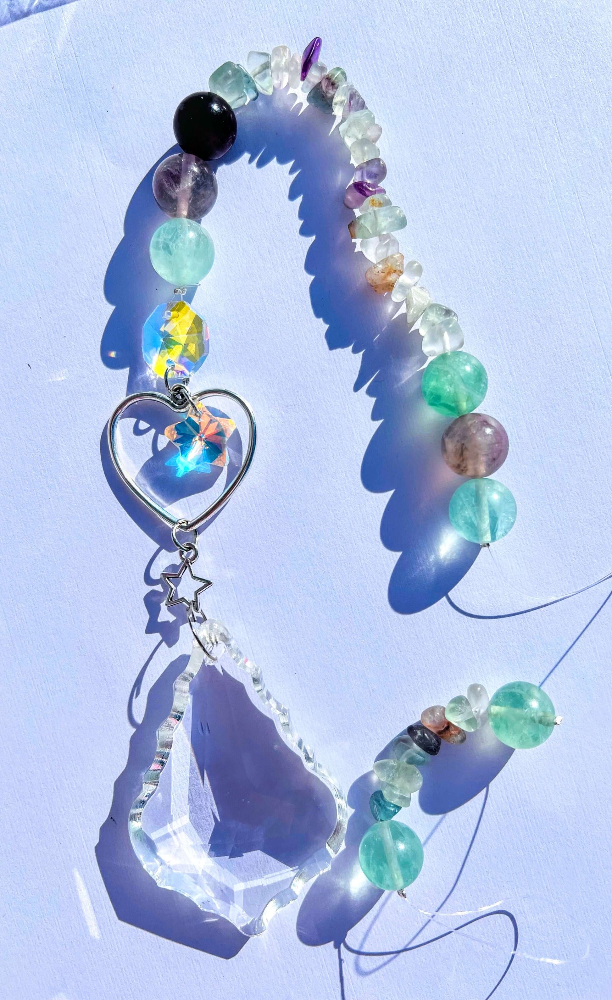 Fluorite crystal sun catcher on white background