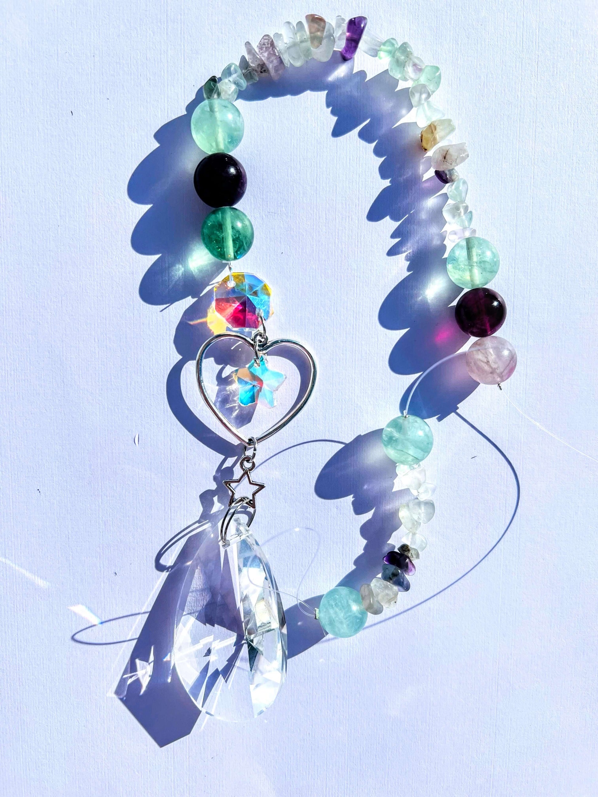 Fluorite crystal sun catcher on white background