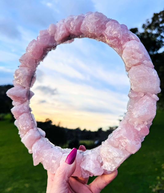 Handmade crystal mirror with gemstone border reflecting natural light