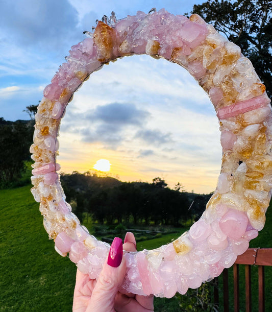 Handmade crystal mirror with gemstone border reflecting natural light