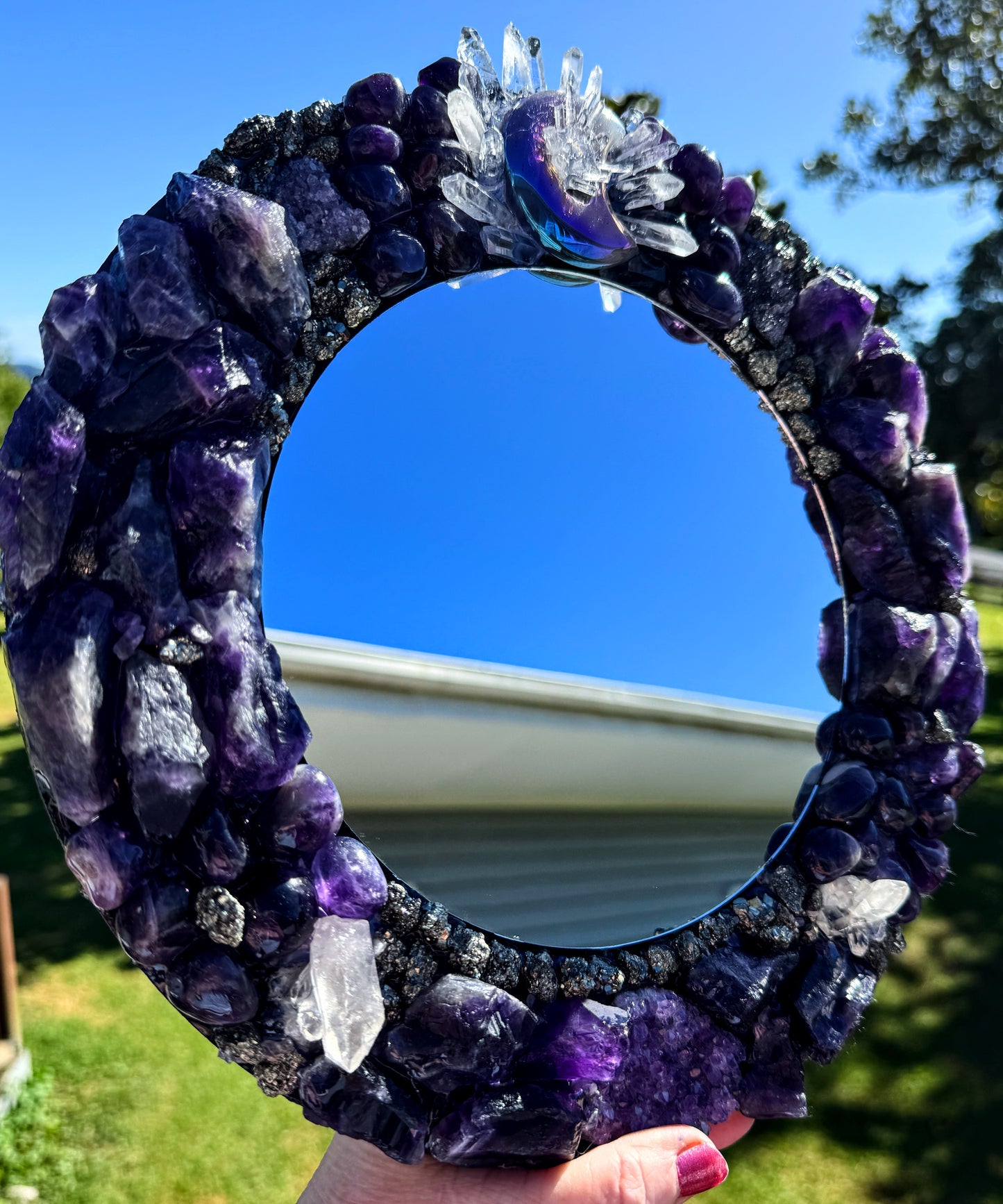 Moonlight Magic Crystal Mirror 28cm with amethyst, clear quartz, pyrite, and agate crescent moon on a sunny day