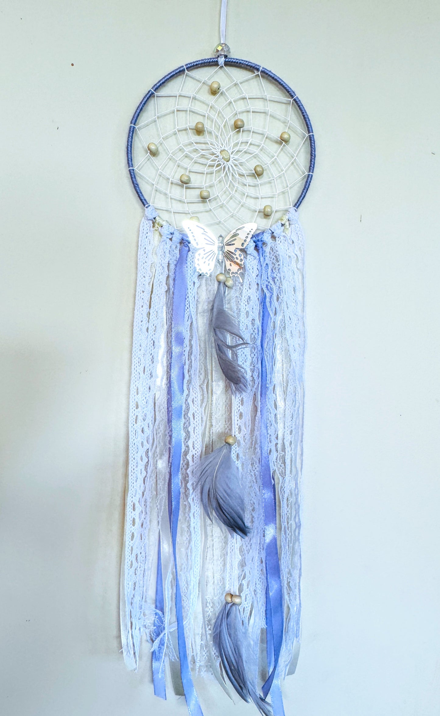 Lavender dream catcher featuring delicate lace, flowing ribbons, and feather details in soothing colors.
