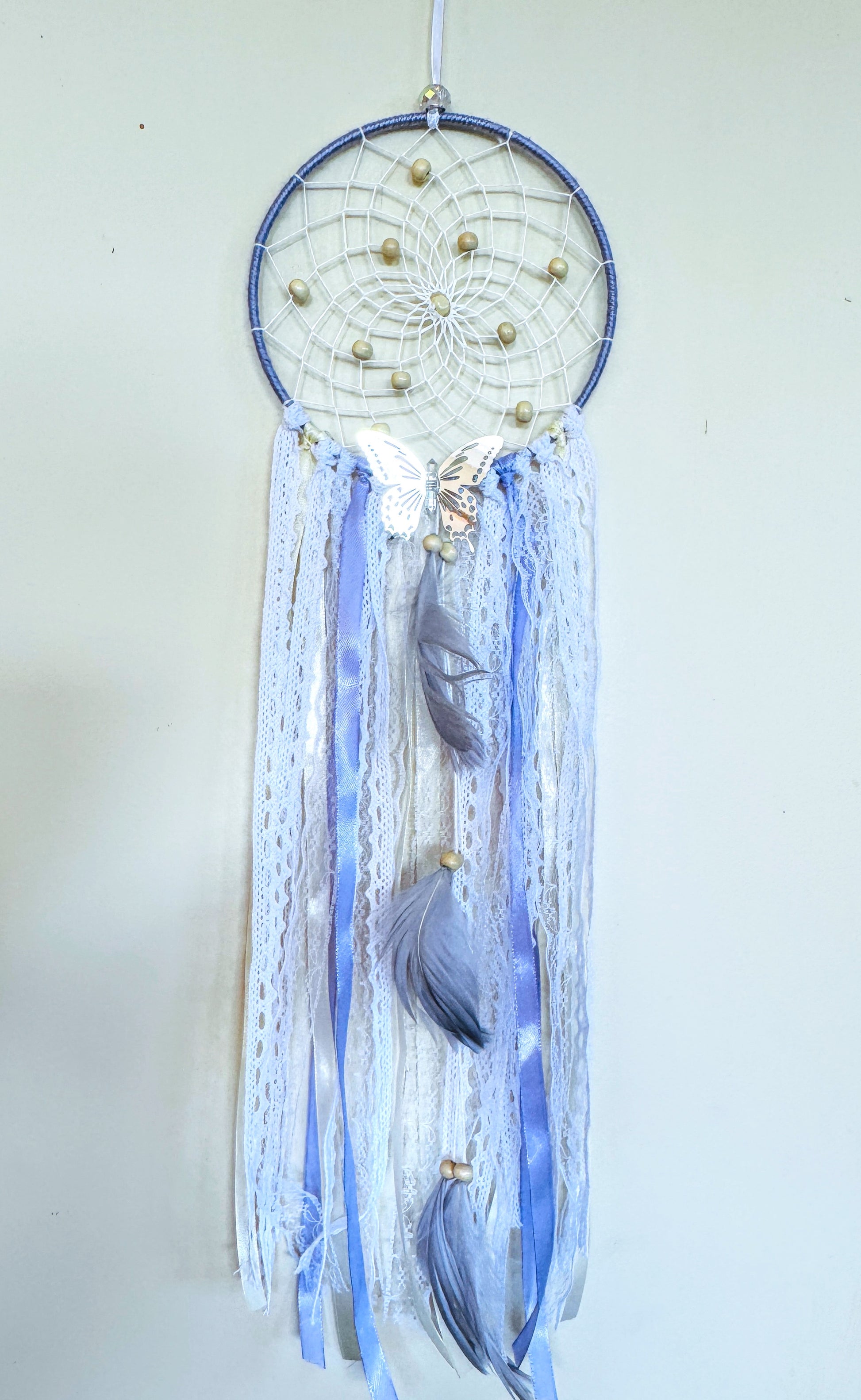 Lavender dream catcher featuring delicate lace, flowing ribbons, and feather details in soothing colors.
