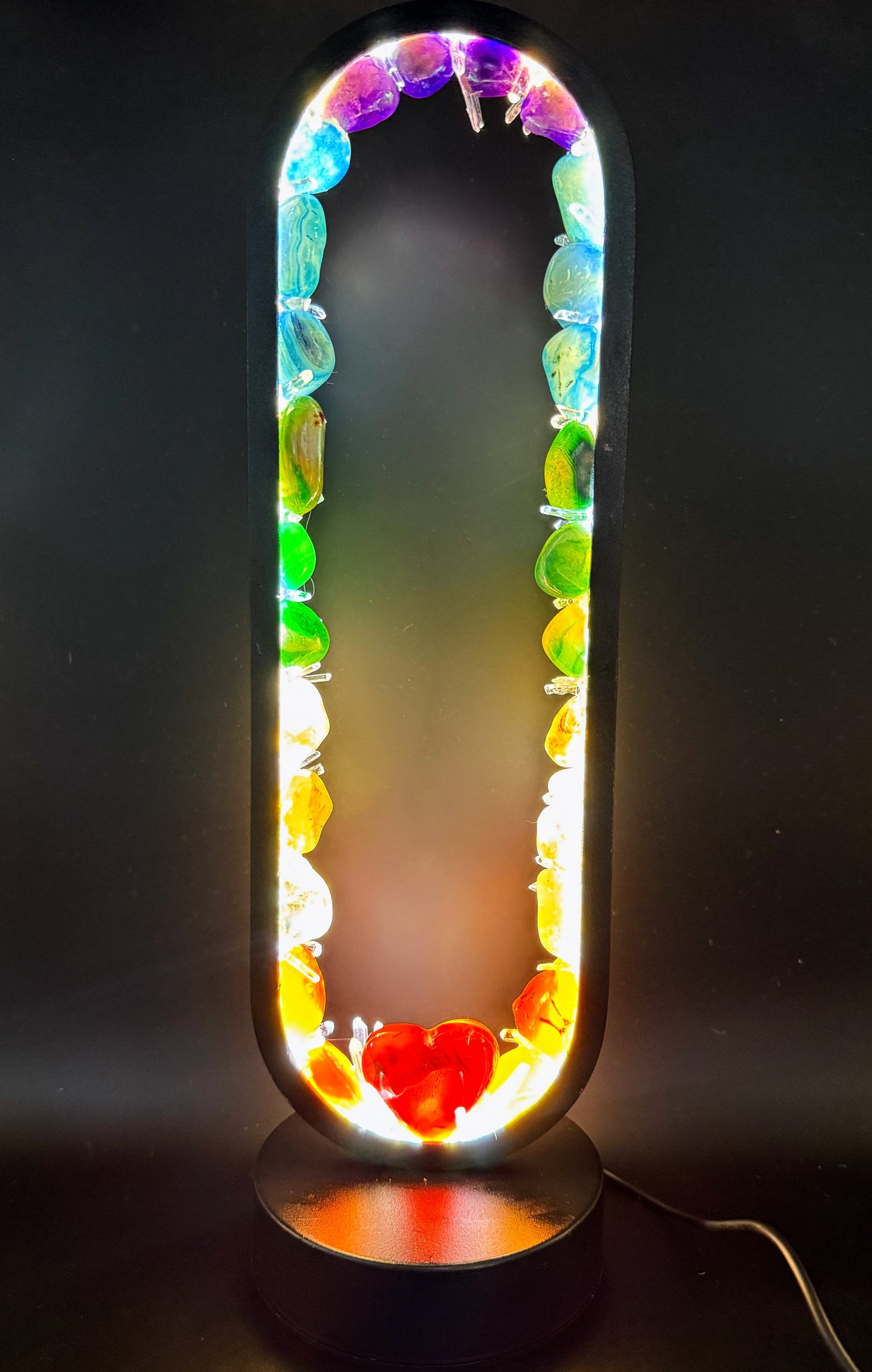 Crystal lamp featuring colorful crystals and a carved carnelian heart, designed to create a vibrant atmosphere.