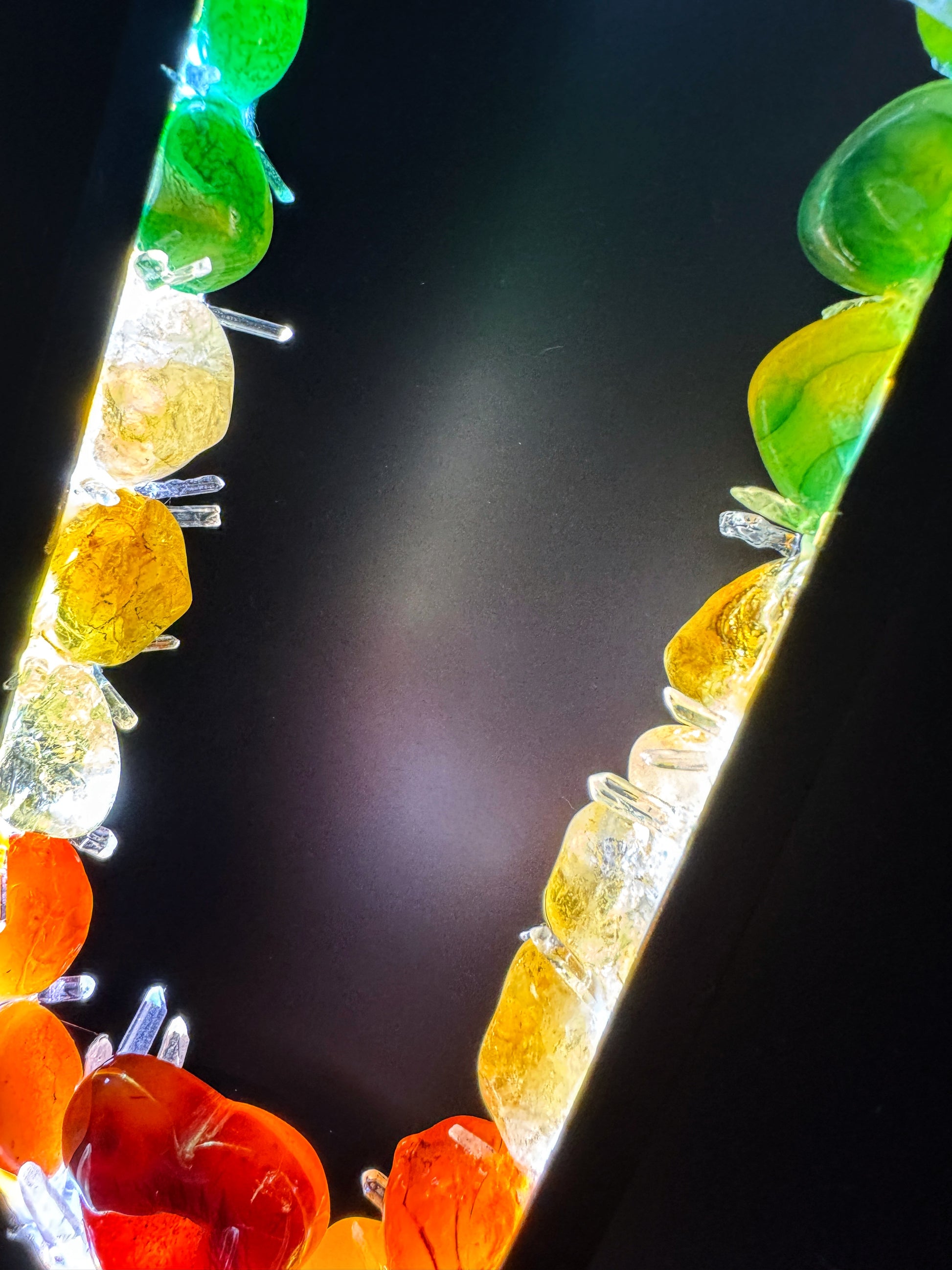 Crystal lamp with colorful polished crystals in a rainbow pattern, highlighting vibrant reds, oranges, yellows, greens, and blues.