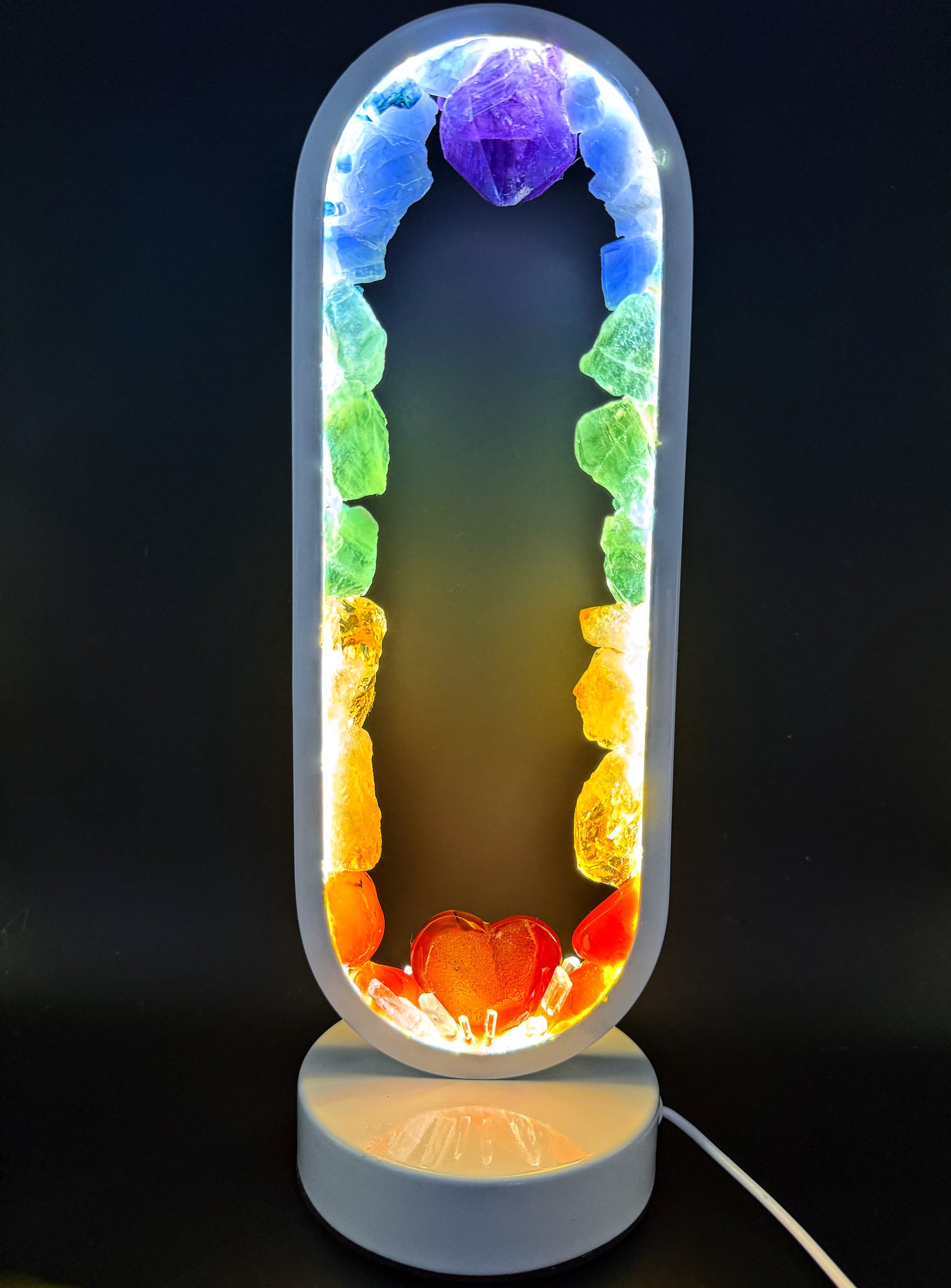 Crystal Lamp with rough rainbow stones and carnelian heart, creating a soft glowing effect.