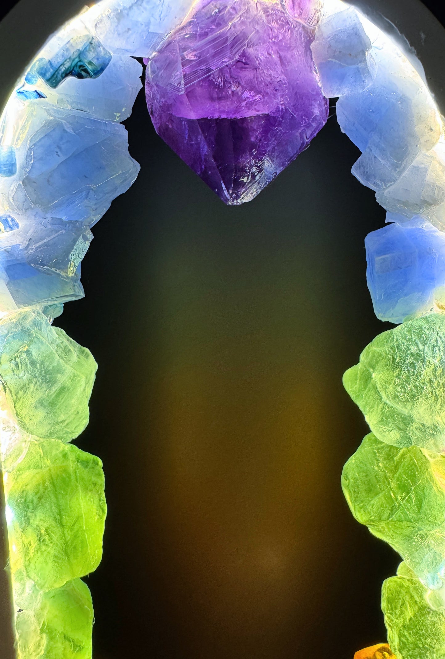 Crystal Lamp featuring a rainbow of rough, unpolished stones creating a glowing effect.