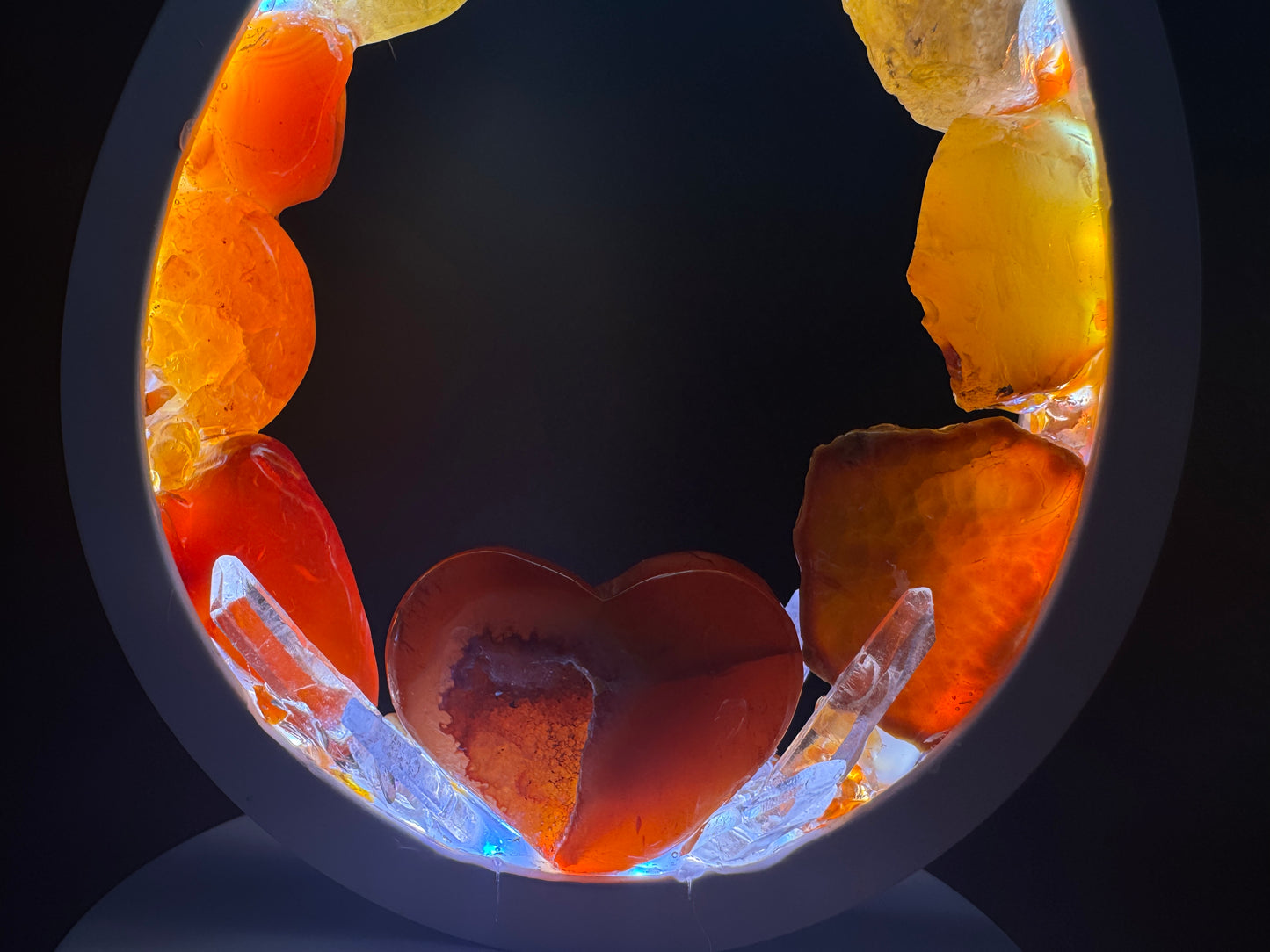 Flame Crystal lamp featuring a heart-shaped carnelian centerpiece and colorful rough stones.