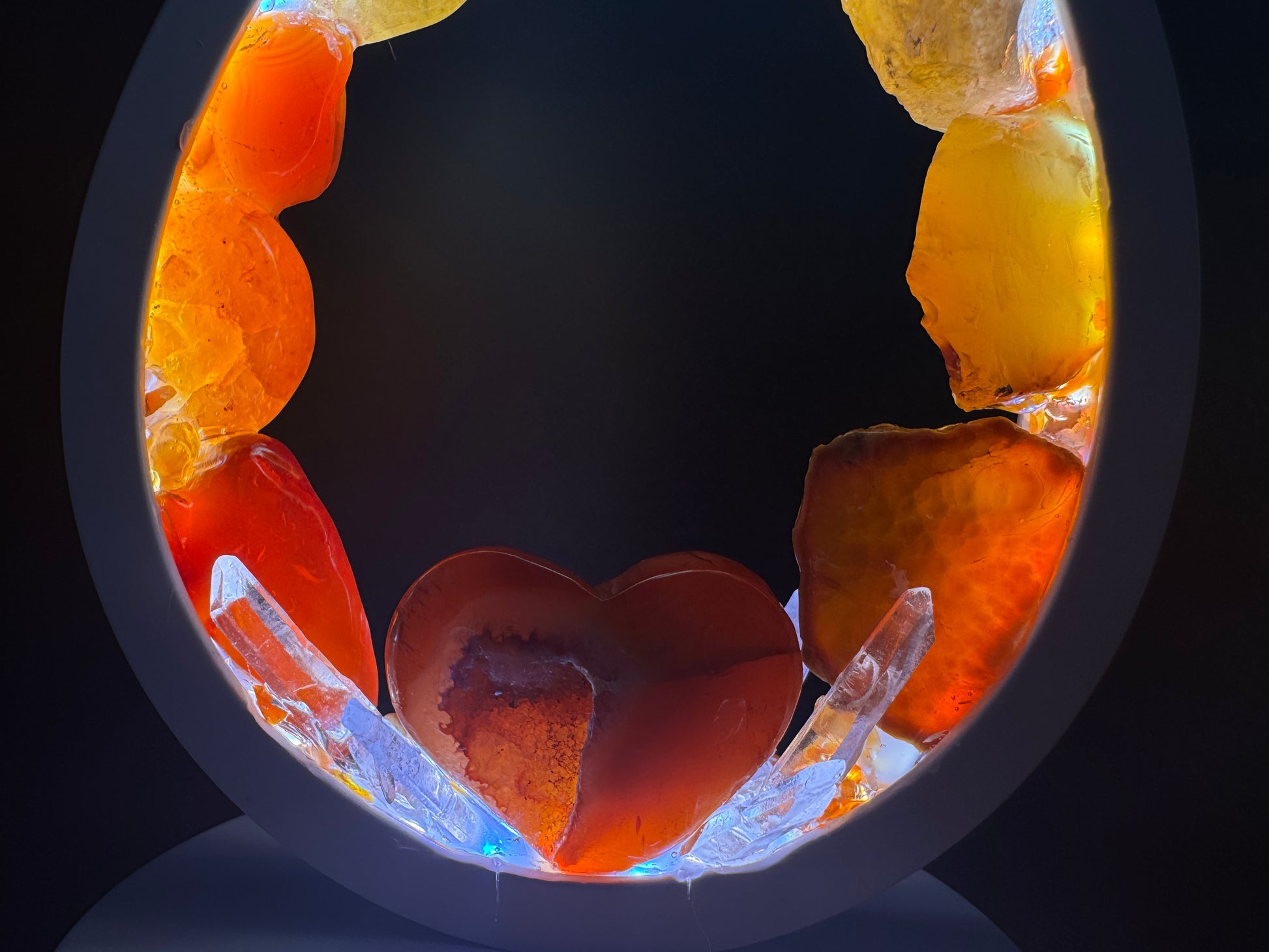 Flame Crystal lamp featuring a heart-shaped carnelian centerpiece and colorful rough stones.